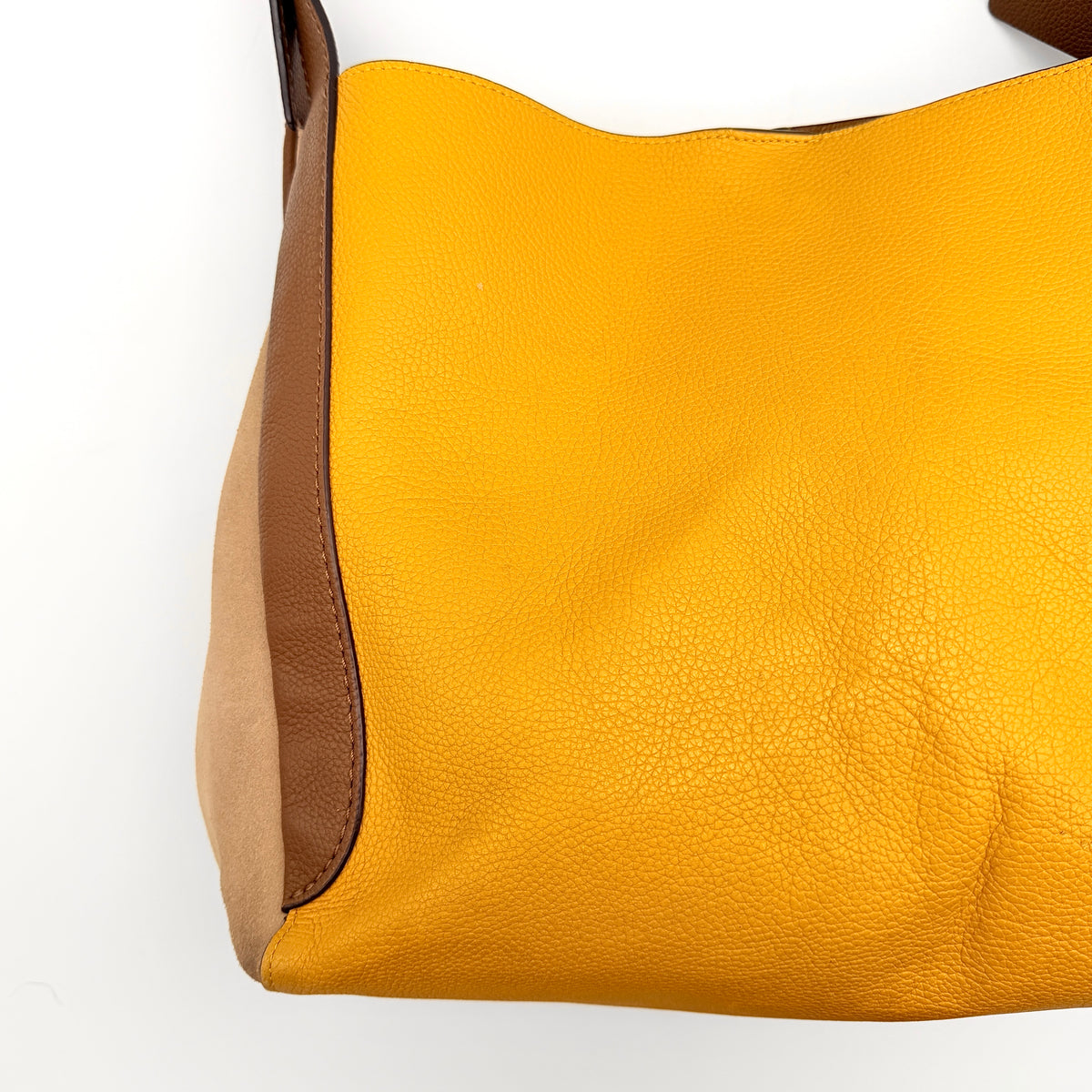 Coach Hadley Colorblock Hobo bag in yellow and brown leather with double top handles and suede side panels, shown against a white background.