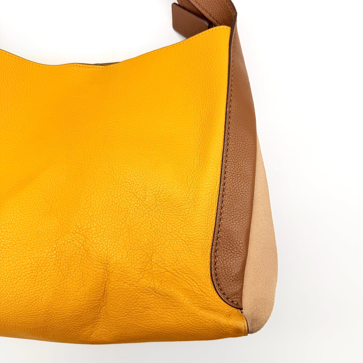 Coach Hadley Colorblock Hobo bag in yellow and brown leather with double top handles and suede side panels, shown against a white background.