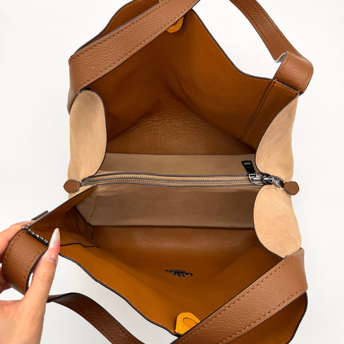 Coach Hadley Colorblock Hobo bag in yellow and brown leather with double top handles and suede side panels, shown against a white background.