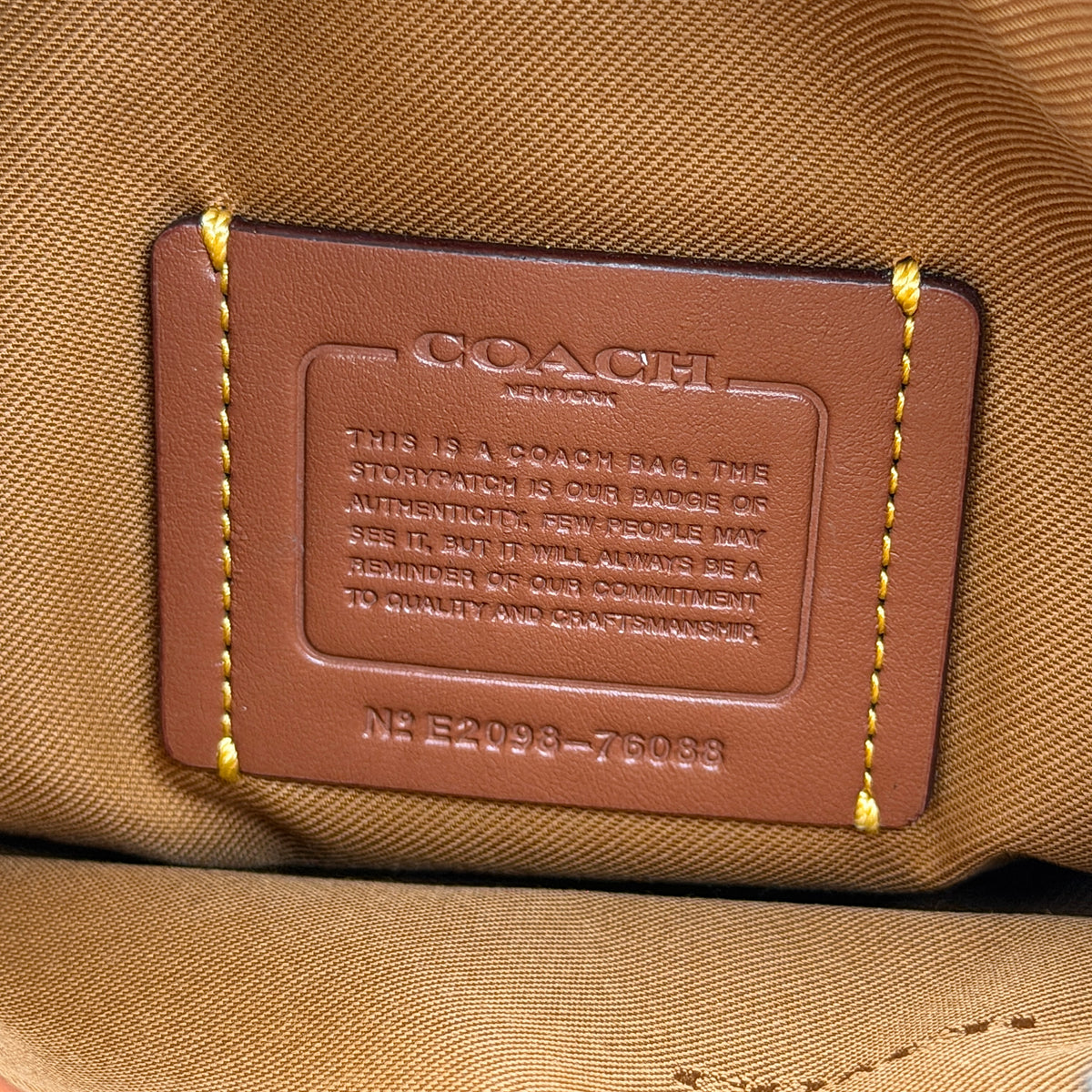 Coach Hadley Colorblock Hobo bag in yellow and brown leather with double top handles and suede side panels, shown against a white background.