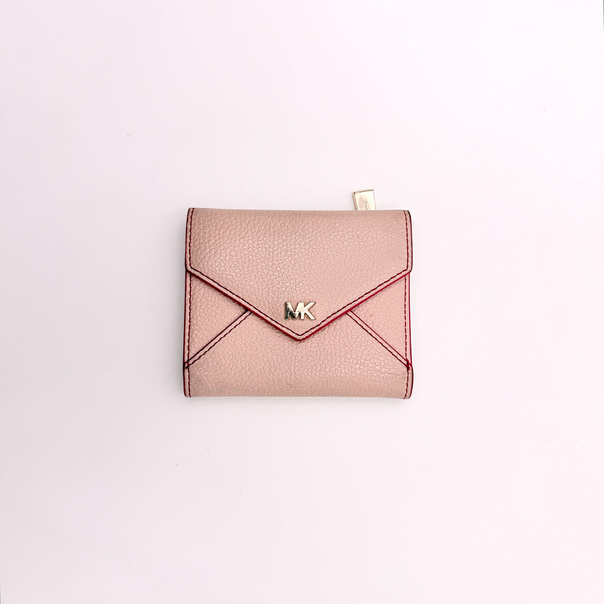 Michael Kors pink leather envelope trifold wallet with gold MK logo, shown closed on a white background.
