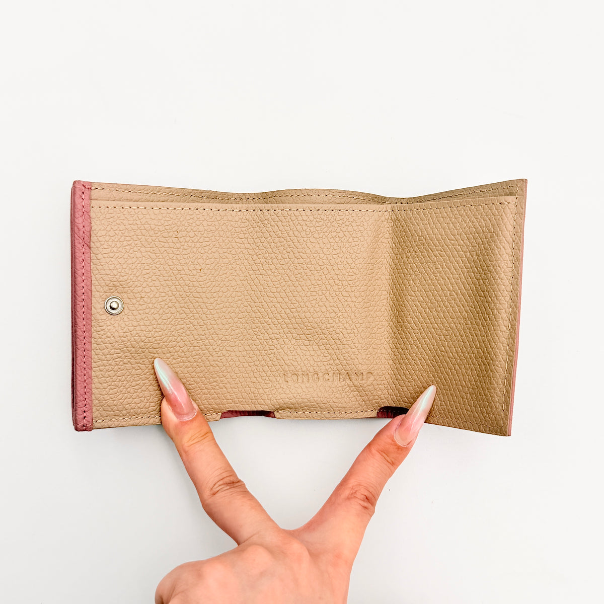 Longchamp Le Roseau compact wallet in pink grained leather with signature silver bamboo clasp.