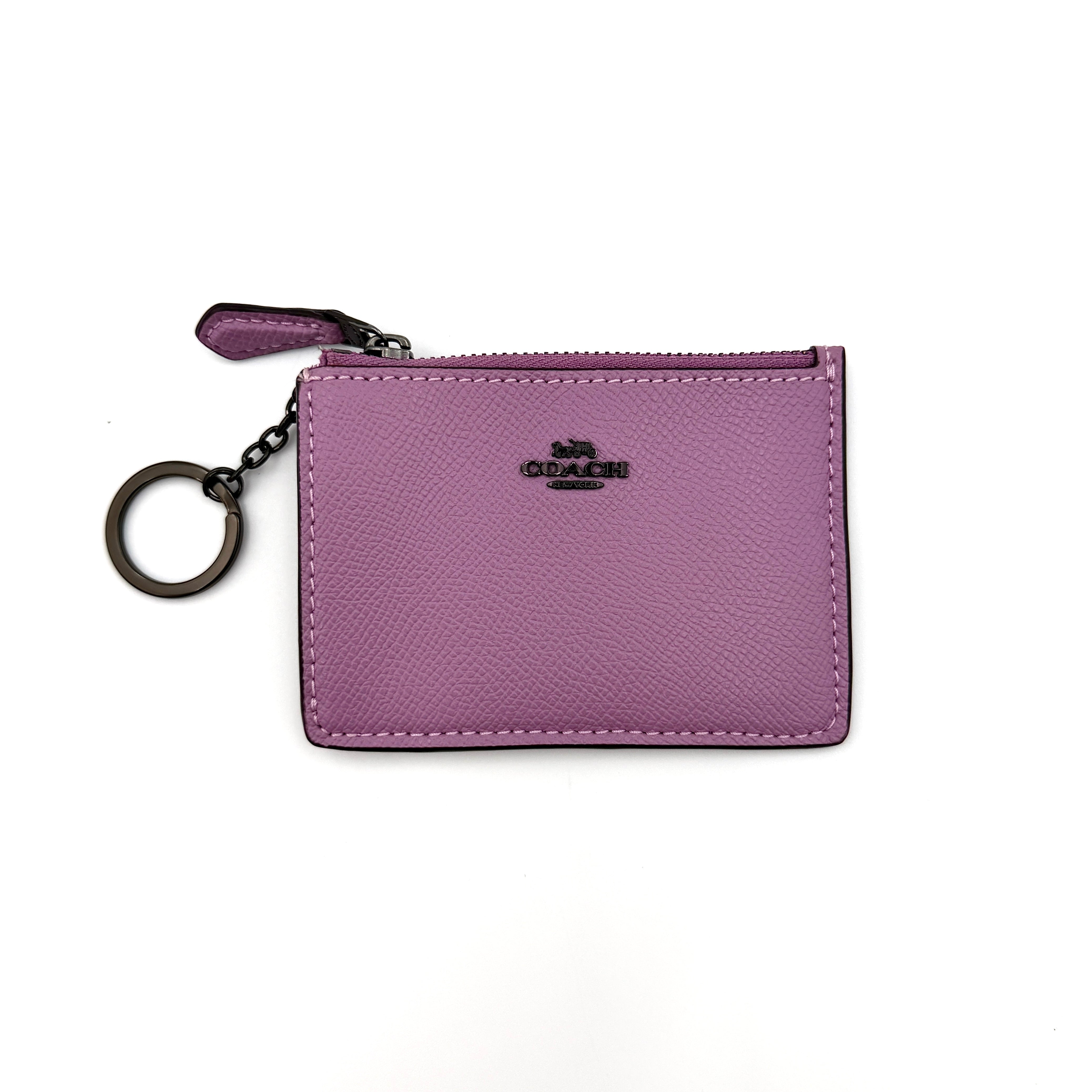 Coach Mini Skinny ID Case in purple pebbled leather with black hardware, featuring a zip closure and key ring.