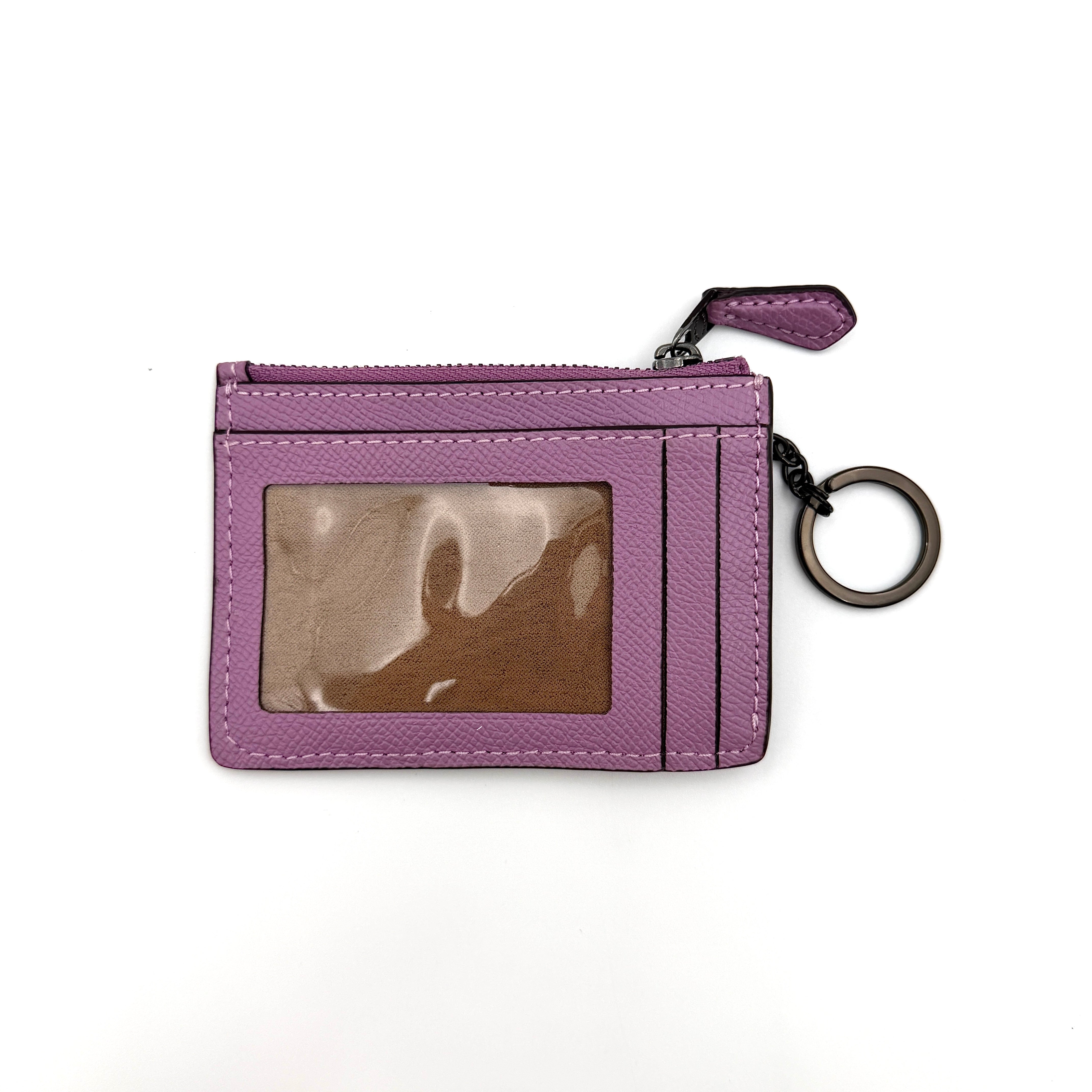 Coach Mini Skinny ID Case in purple pebbled leather with black hardware, featuring a zip closure and key ring.