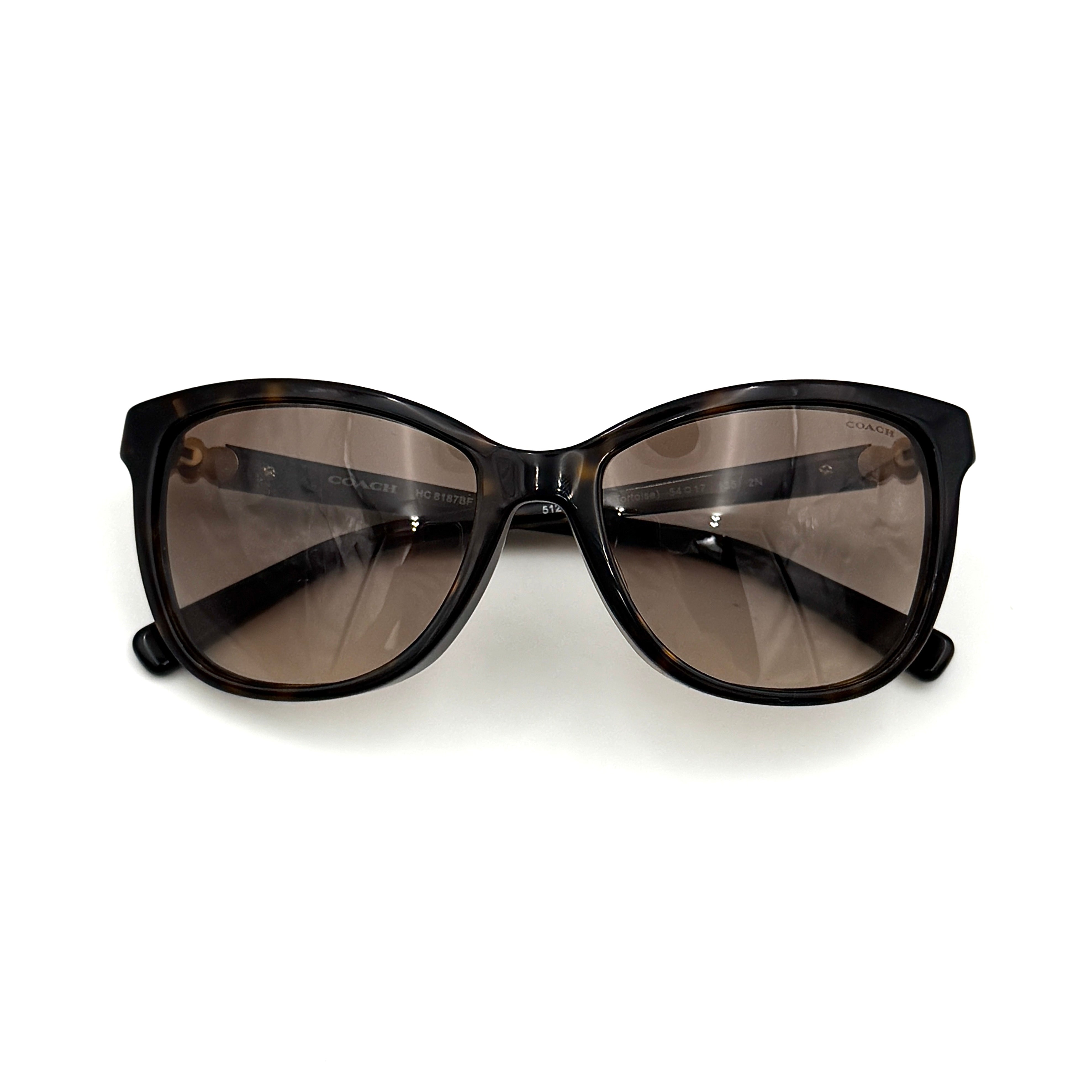 Coach HC8187BF sunglasses in dark tortoise acetate with gold floral and crystal temple detailing, shown in a three-quarter profile.