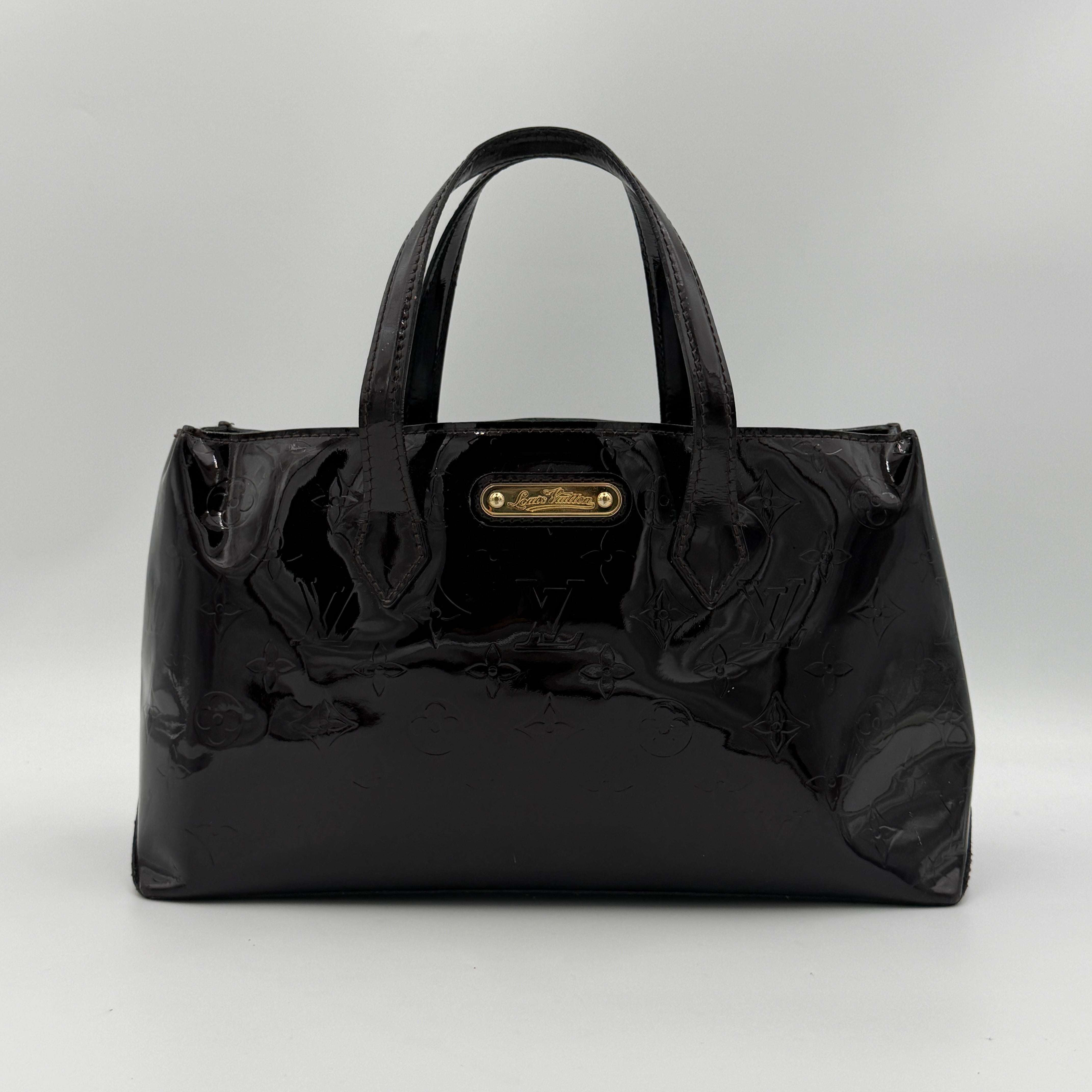 Louis Vuitton Monogram Rosewood Avenue Vernis Shoulder Bag in dark purple Vernis leather with gold-tone hardware, shown upright against a neutral backdrop.