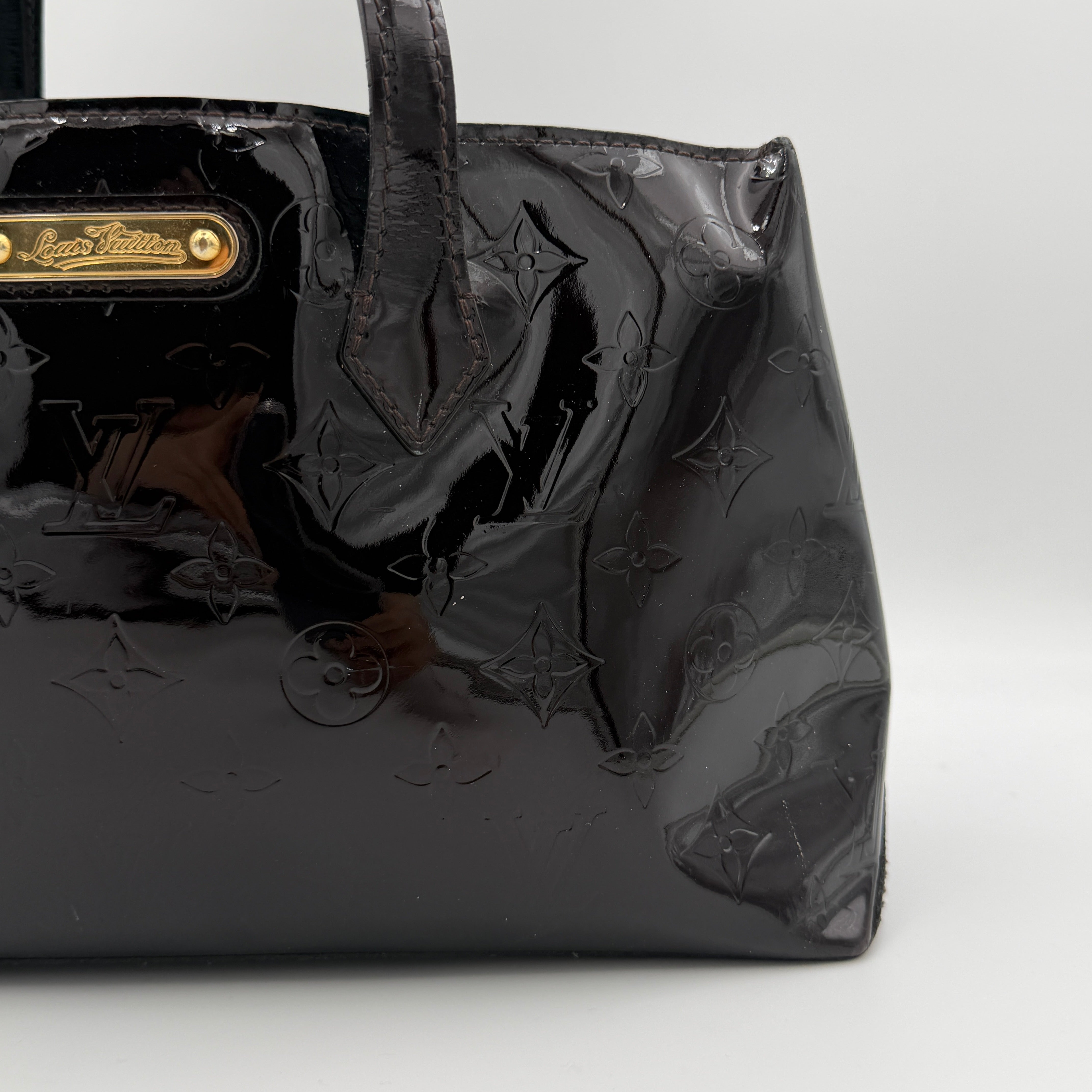 Louis Vuitton Monogram Rosewood Avenue Vernis Shoulder Bag in dark purple Vernis leather with gold-tone hardware, shown upright against a neutral backdrop.