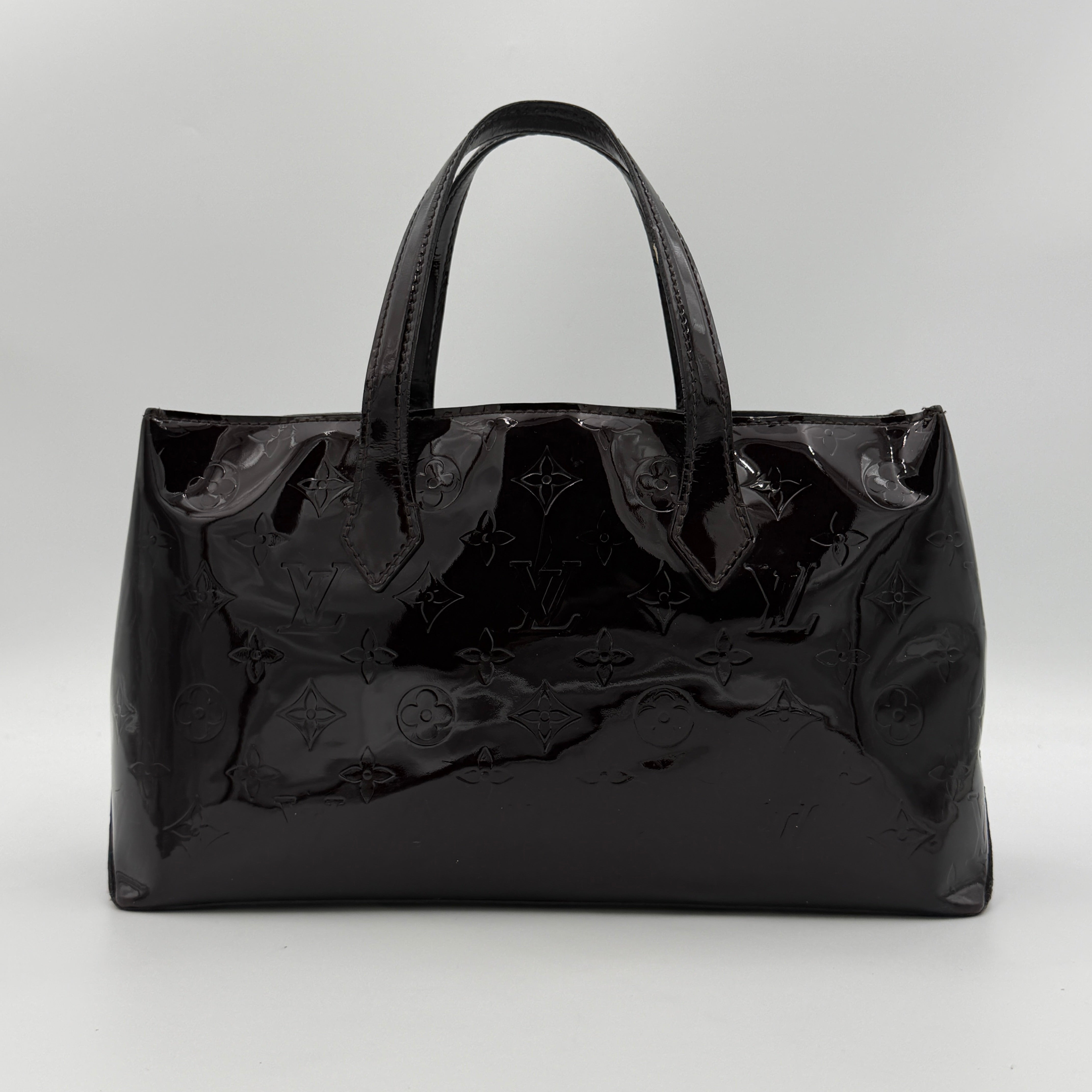 Louis Vuitton Monogram Rosewood Avenue Vernis Shoulder Bag in dark purple Vernis leather with gold-tone hardware, shown upright against a neutral backdrop.