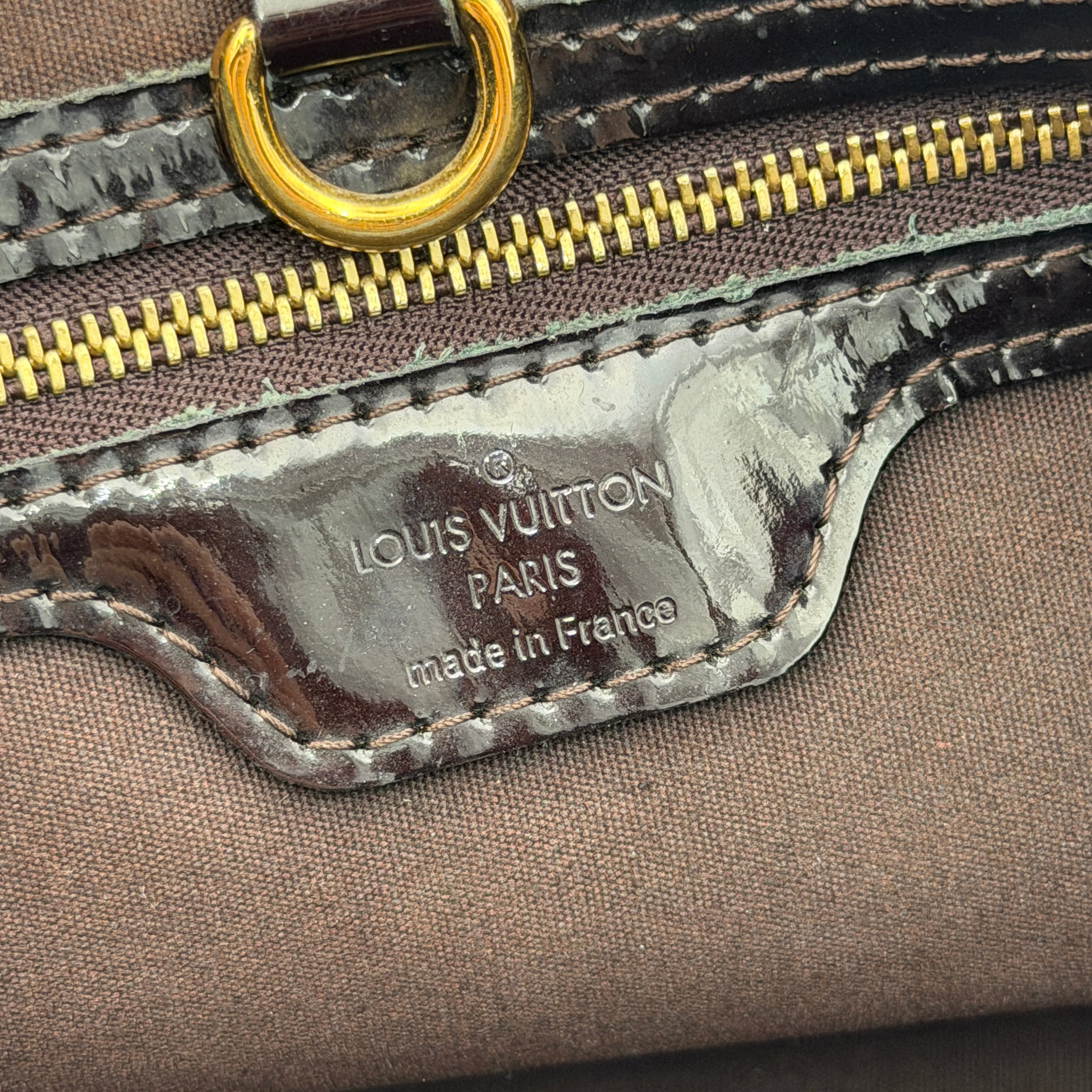 Louis Vuitton Monogram Rosewood Avenue Vernis Shoulder Bag in dark purple Vernis leather with gold-tone hardware, shown upright against a neutral backdrop.