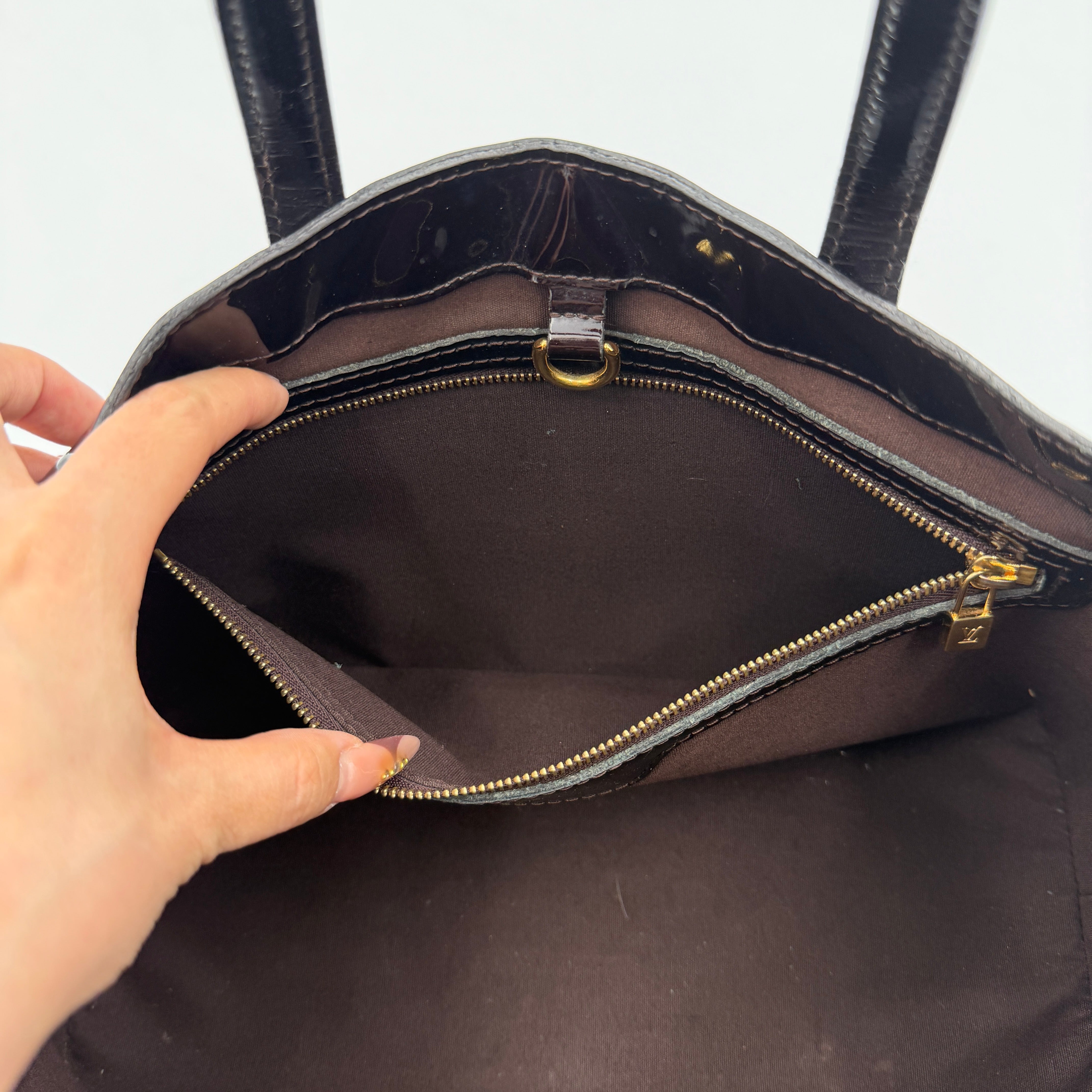Louis Vuitton Monogram Rosewood Avenue Vernis Shoulder Bag in dark purple Vernis leather with gold-tone hardware, shown upright against a neutral backdrop.