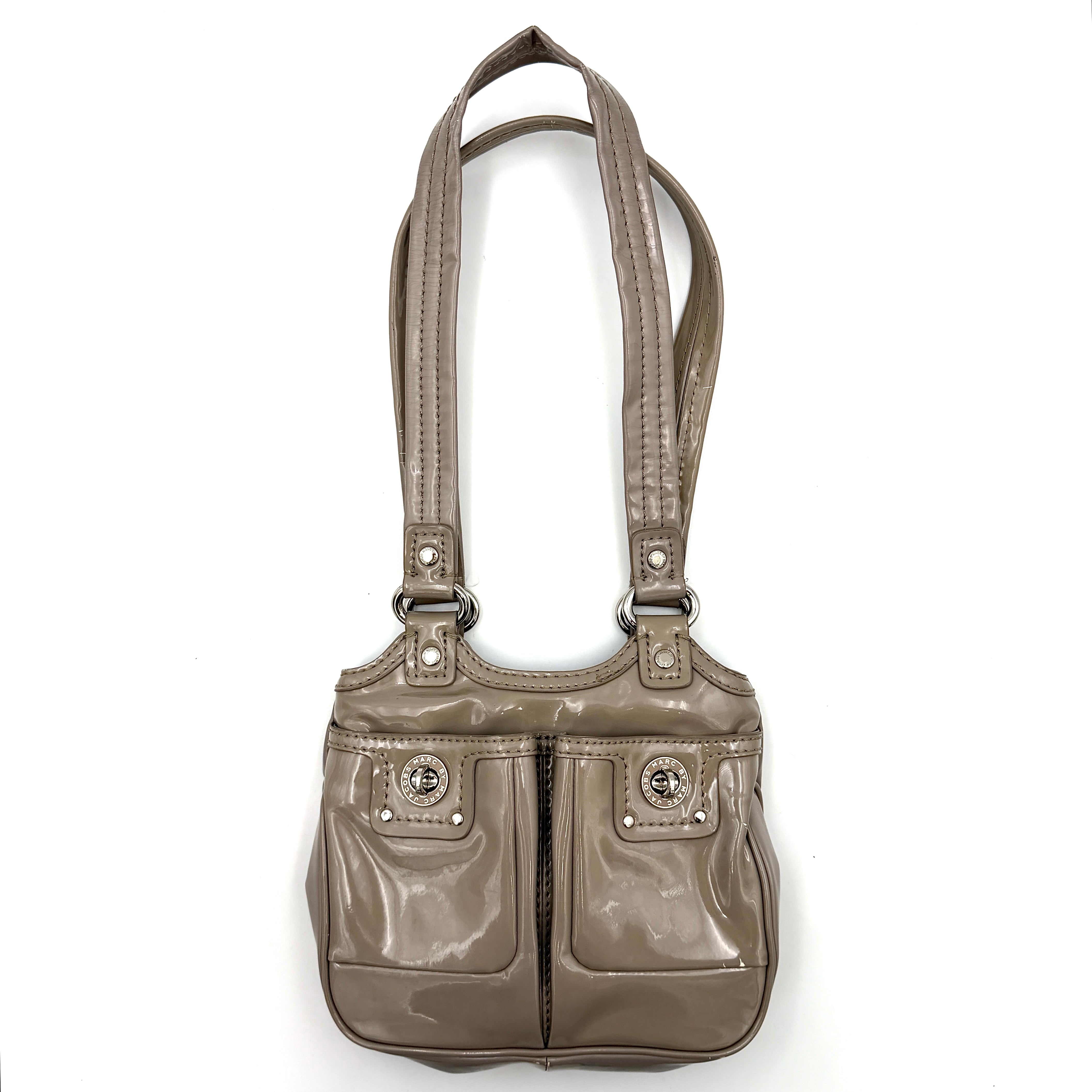 Marc Jacobs grey patent leather shoulder bag with double front turnlock pockets and structured dual handles.