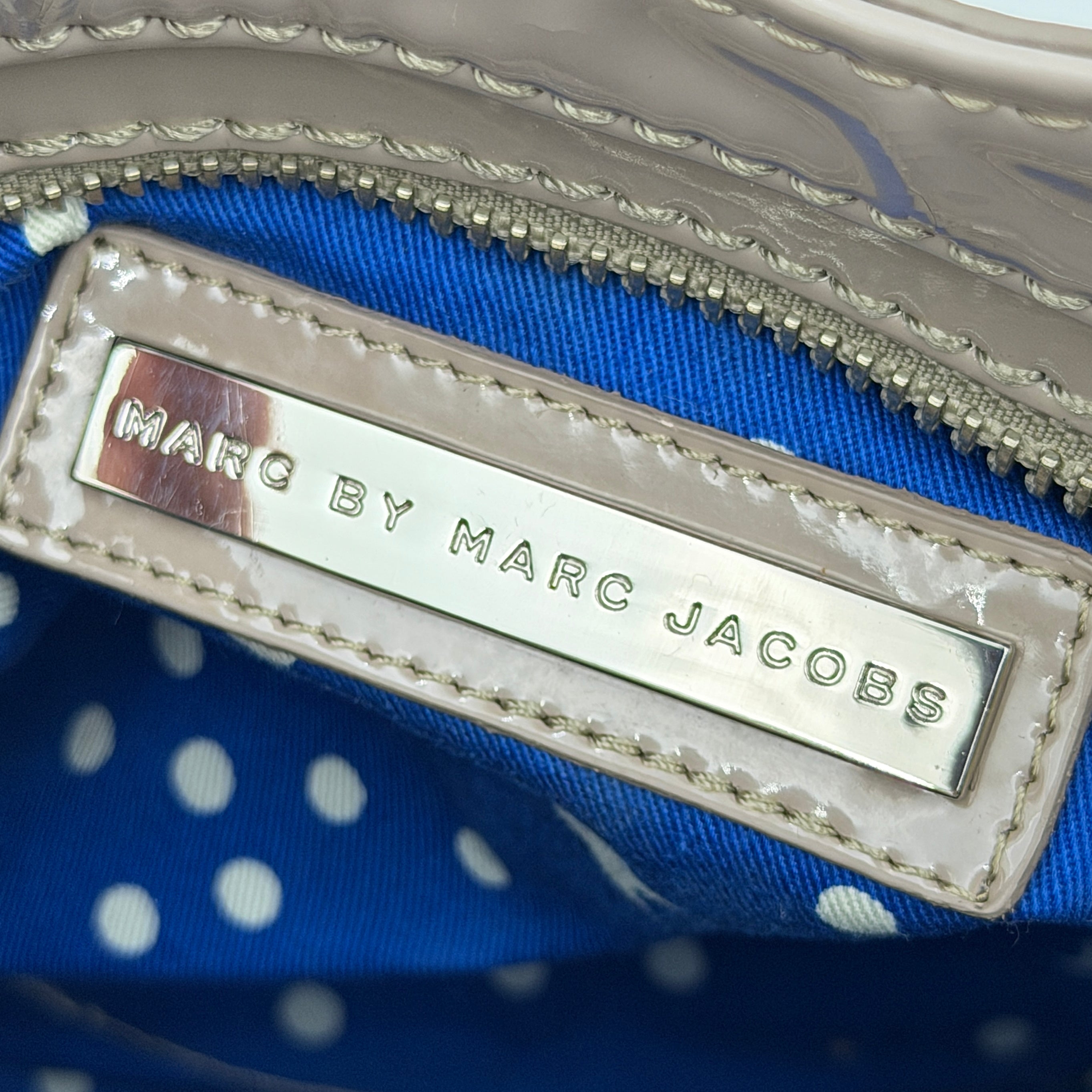 Marc Jacobs grey patent leather shoulder bag with double front turnlock pockets and structured dual handles.