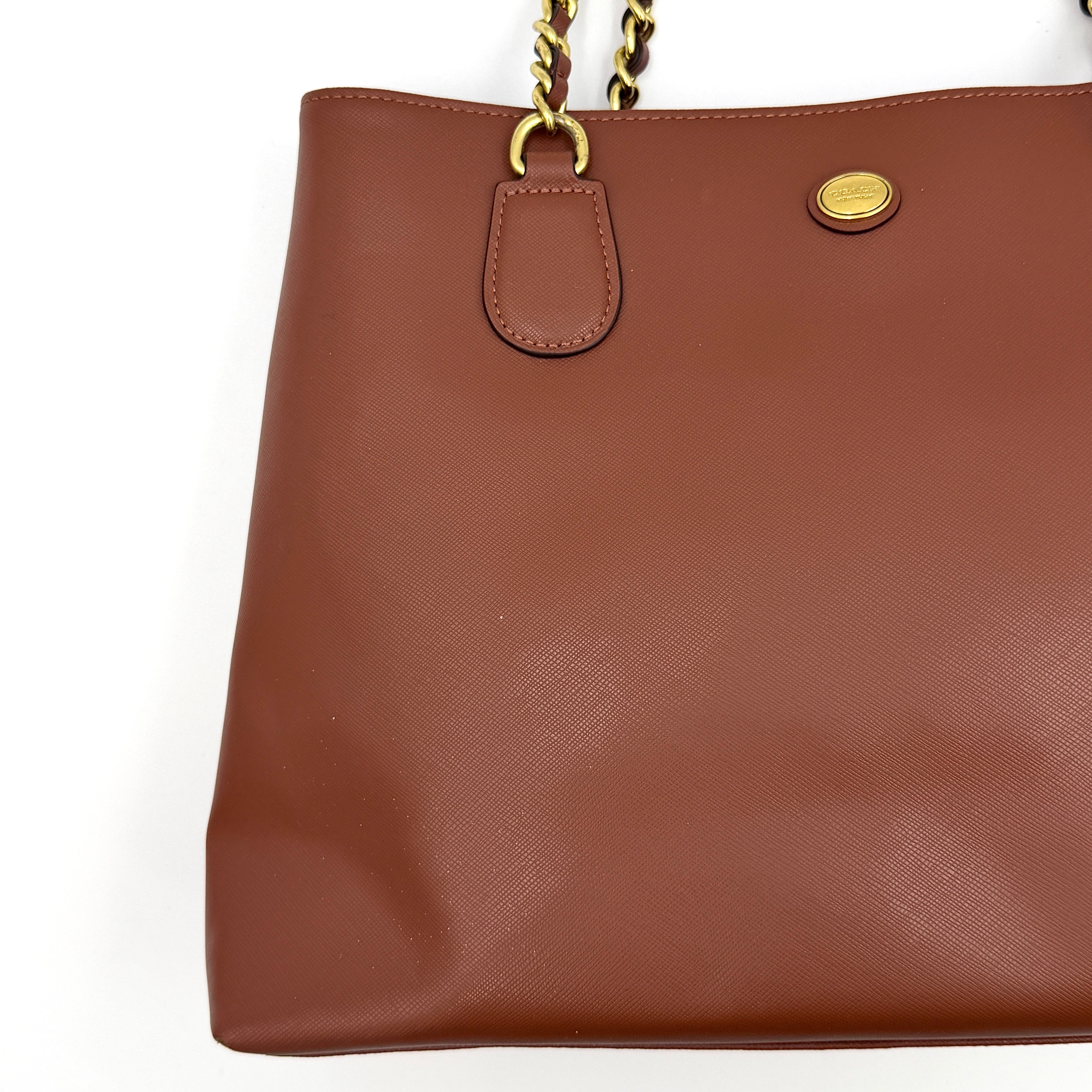 Coach Peyton Chain Shoulder Bag in brown leather with gold-tone chain handles, styled against a clean background.