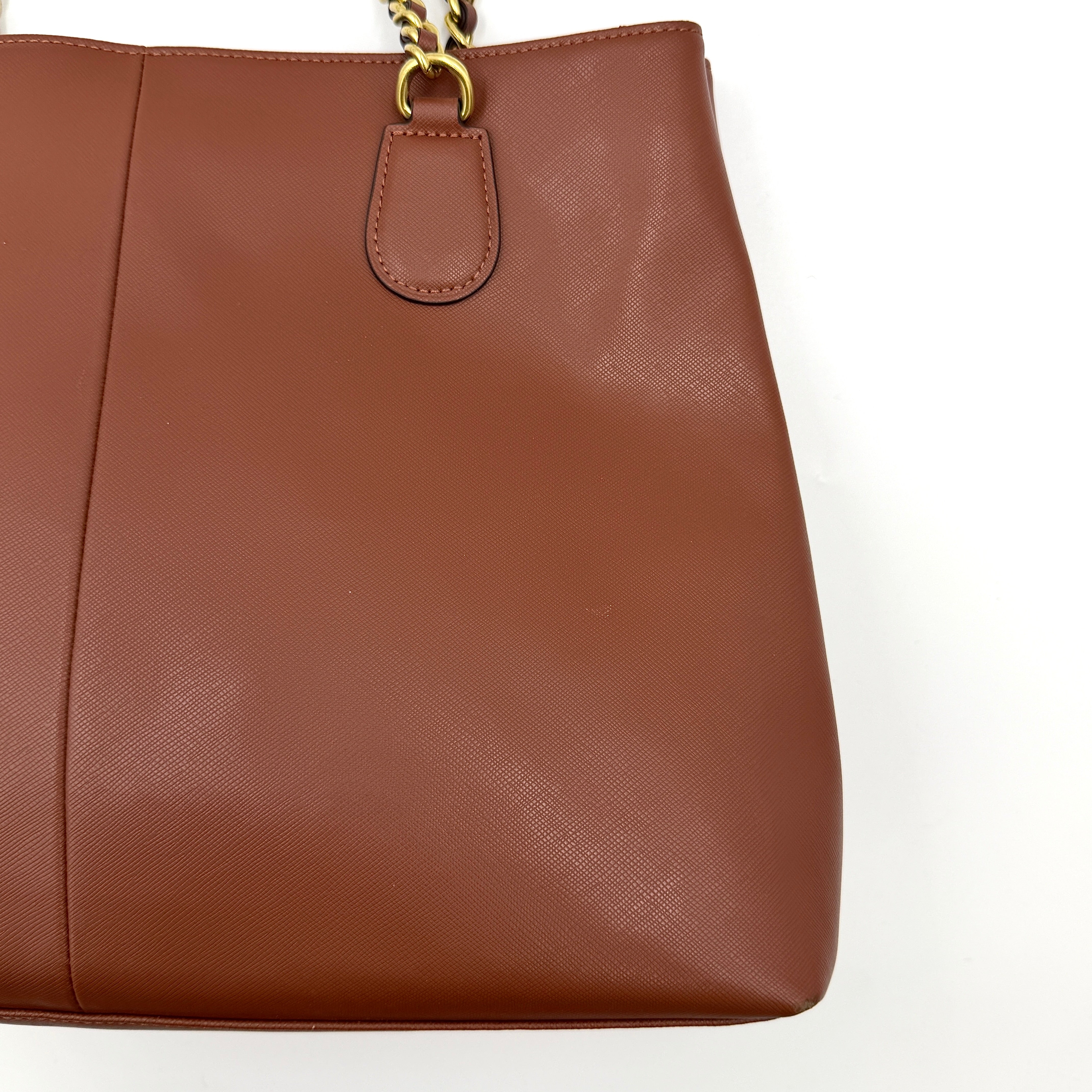 Coach Peyton Chain Shoulder Bag in brown leather with gold-tone chain handles, styled against a clean background.