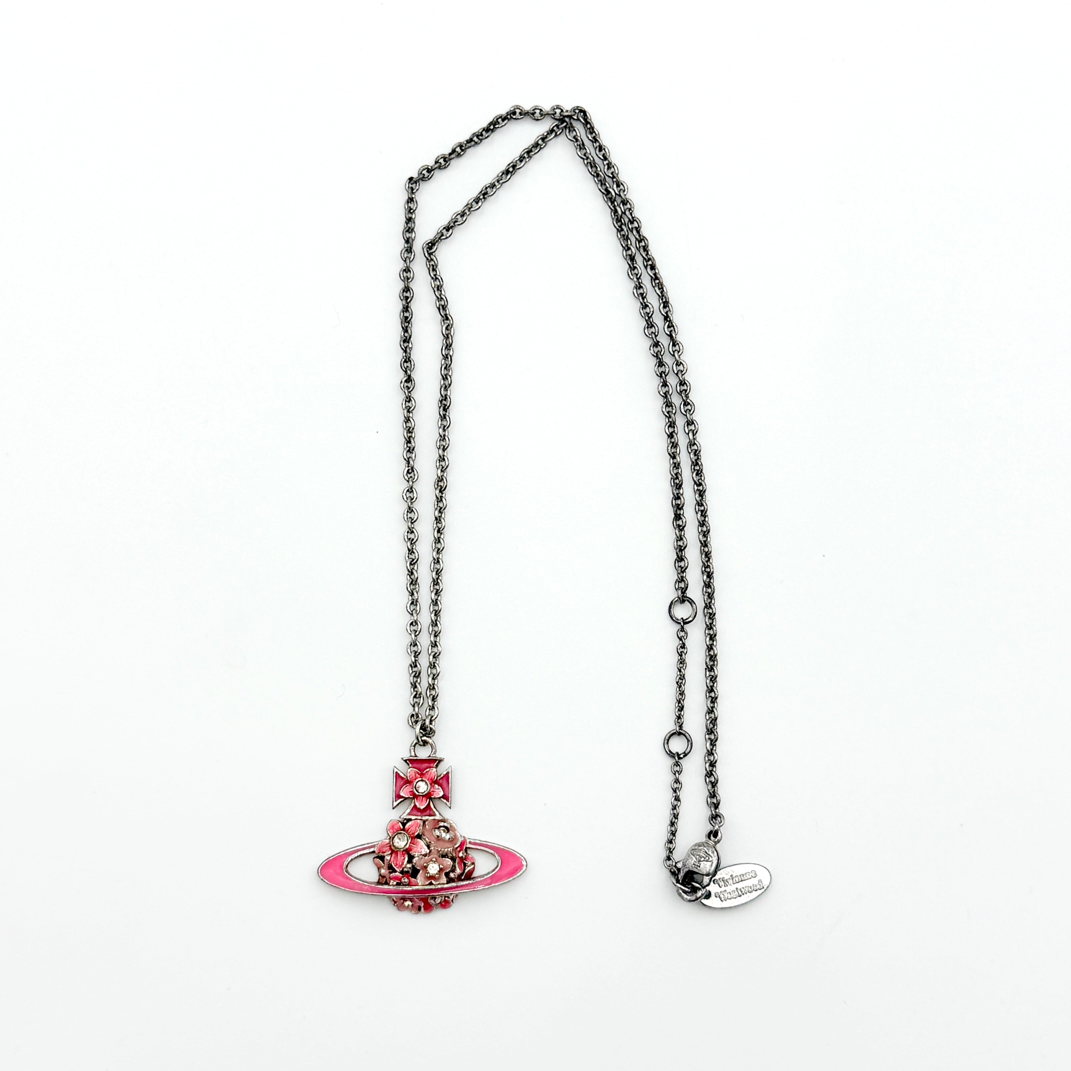 Vivienne Westwood Orb Flower Necklace in silver and pink displayed on a jewelry stand.