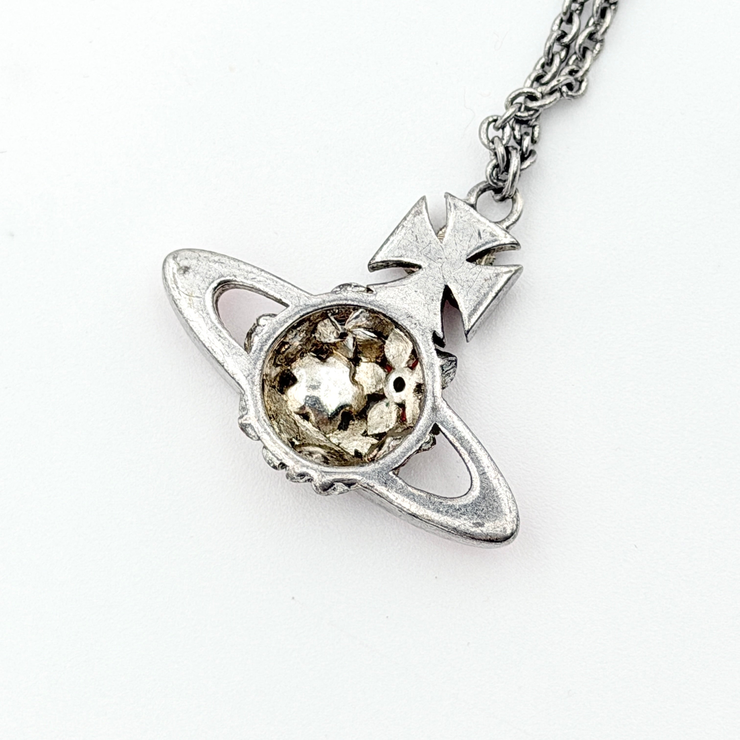 Vivienne Westwood Orb Flower Necklace in silver and pink displayed on a jewelry stand.