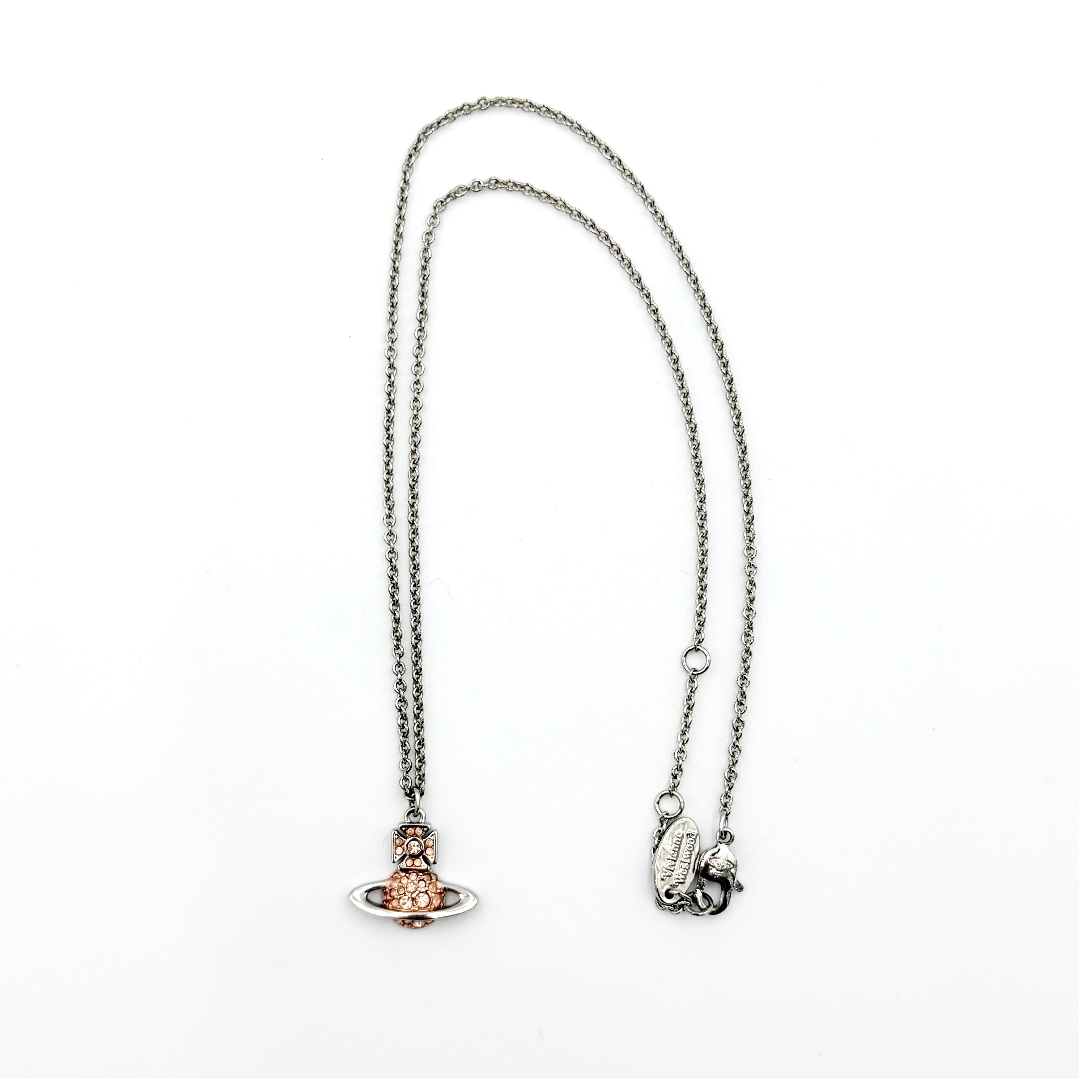Vivienne Westwood Orb Rhinestone Necklace in silver and rose on display against a neutral bust stand
