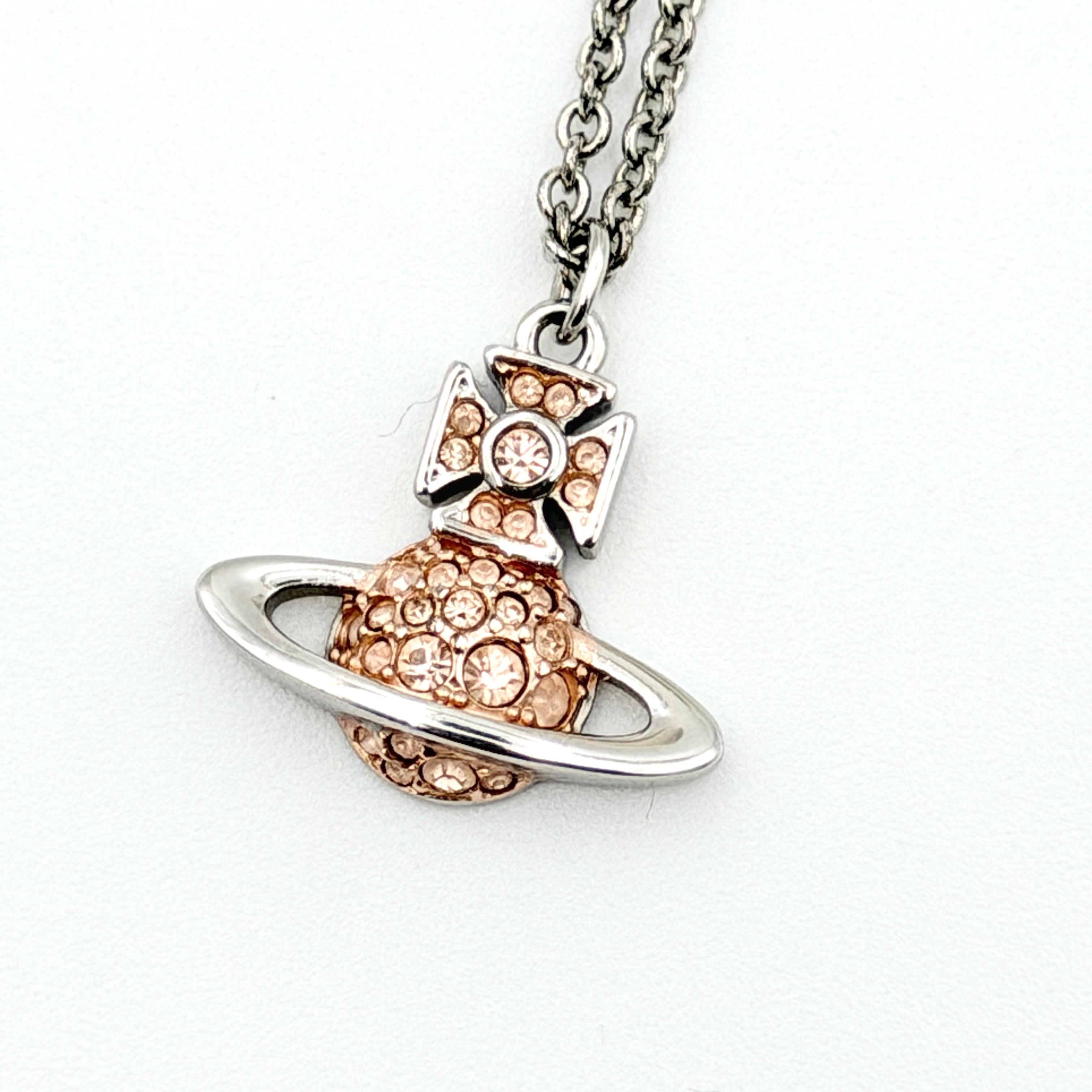 Vivienne Westwood Orb Rhinestone Necklace in silver and rose on display against a neutral bust stand