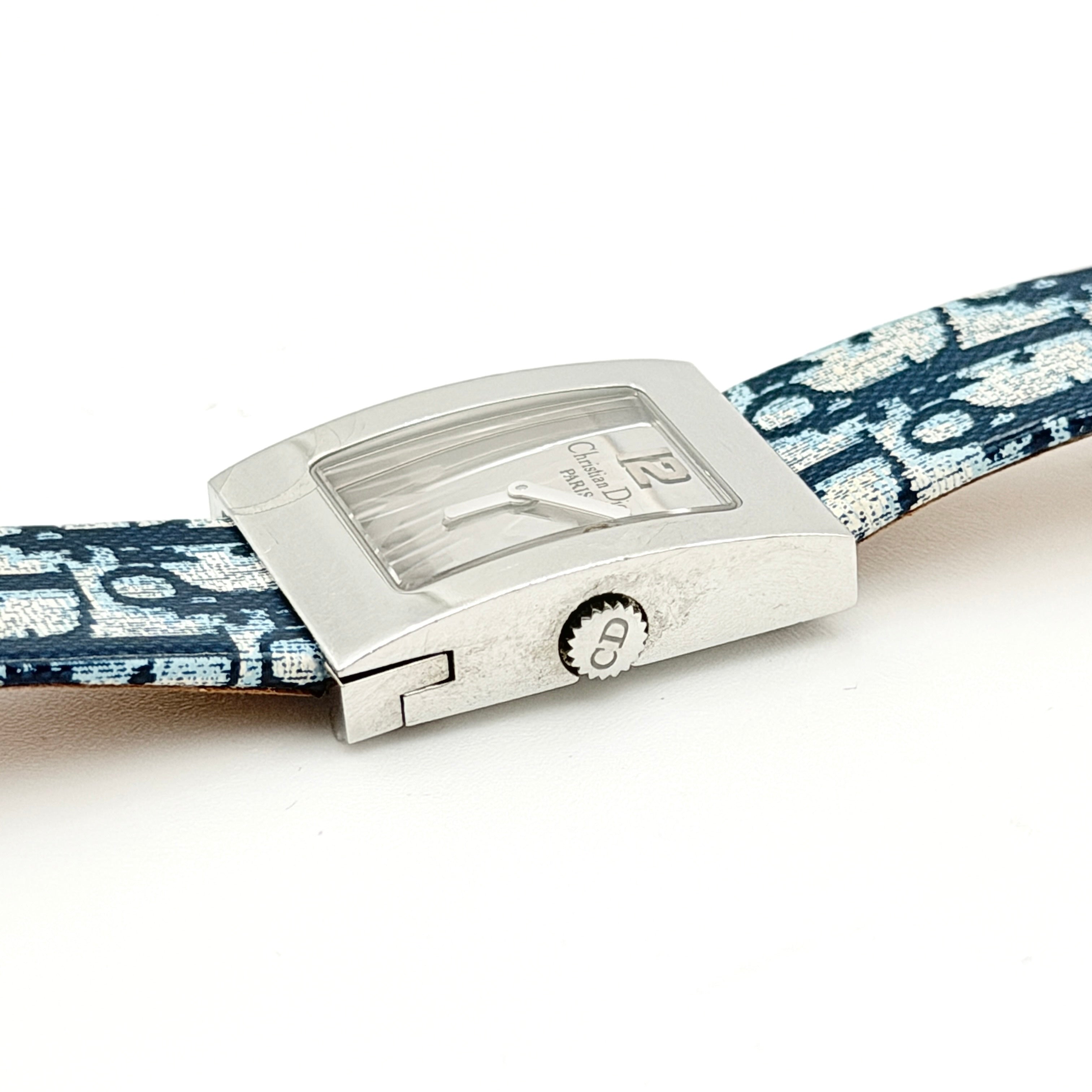 Dior Trotter Malice Watch with blue monogram strap and extra interchangeable yellow and black straps displayed.