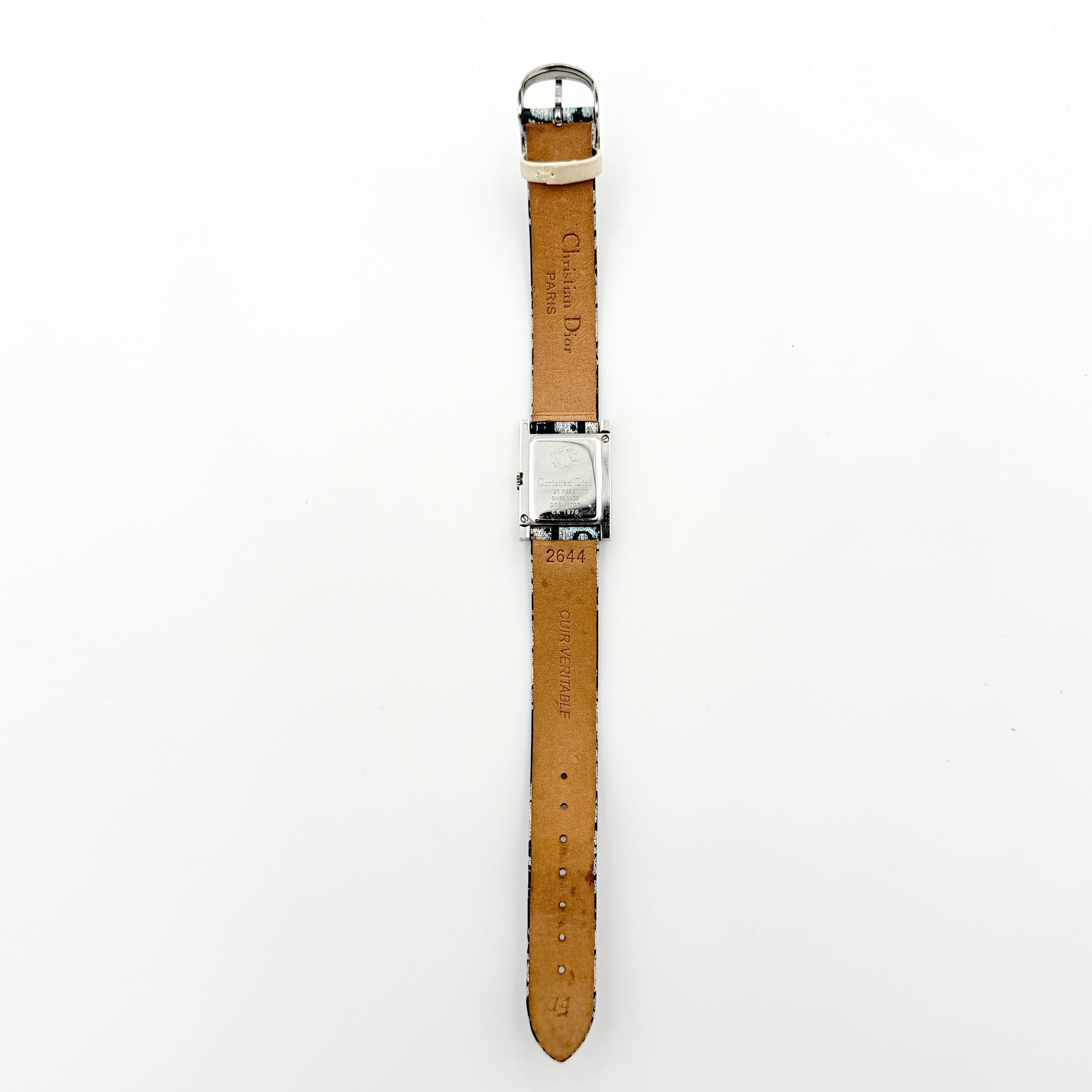 Dior Trotter Malice Watch with blue monogram strap and extra interchangeable yellow and black straps displayed.