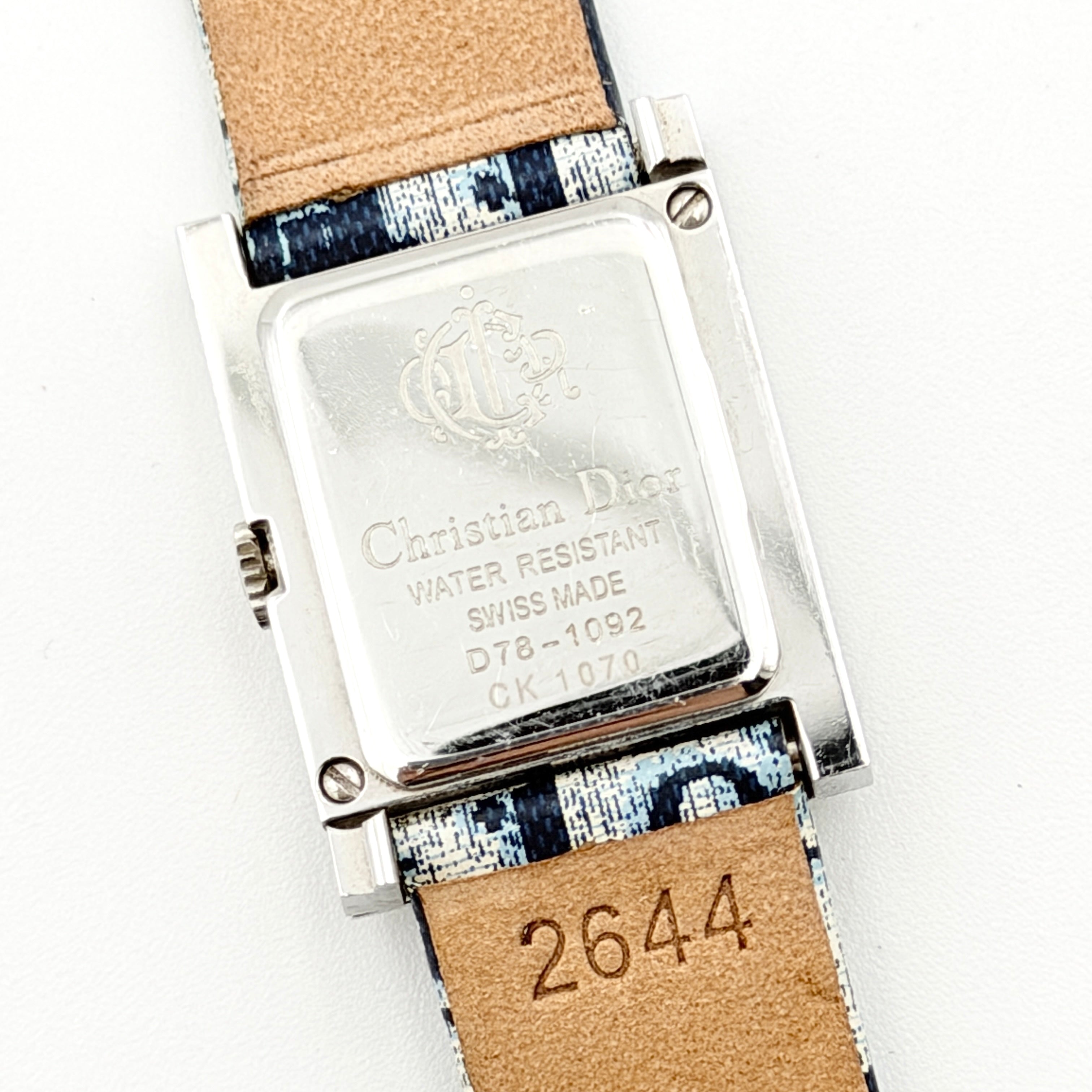 Dior Trotter Malice Watch with blue monogram strap and extra interchangeable yellow and black straps displayed.