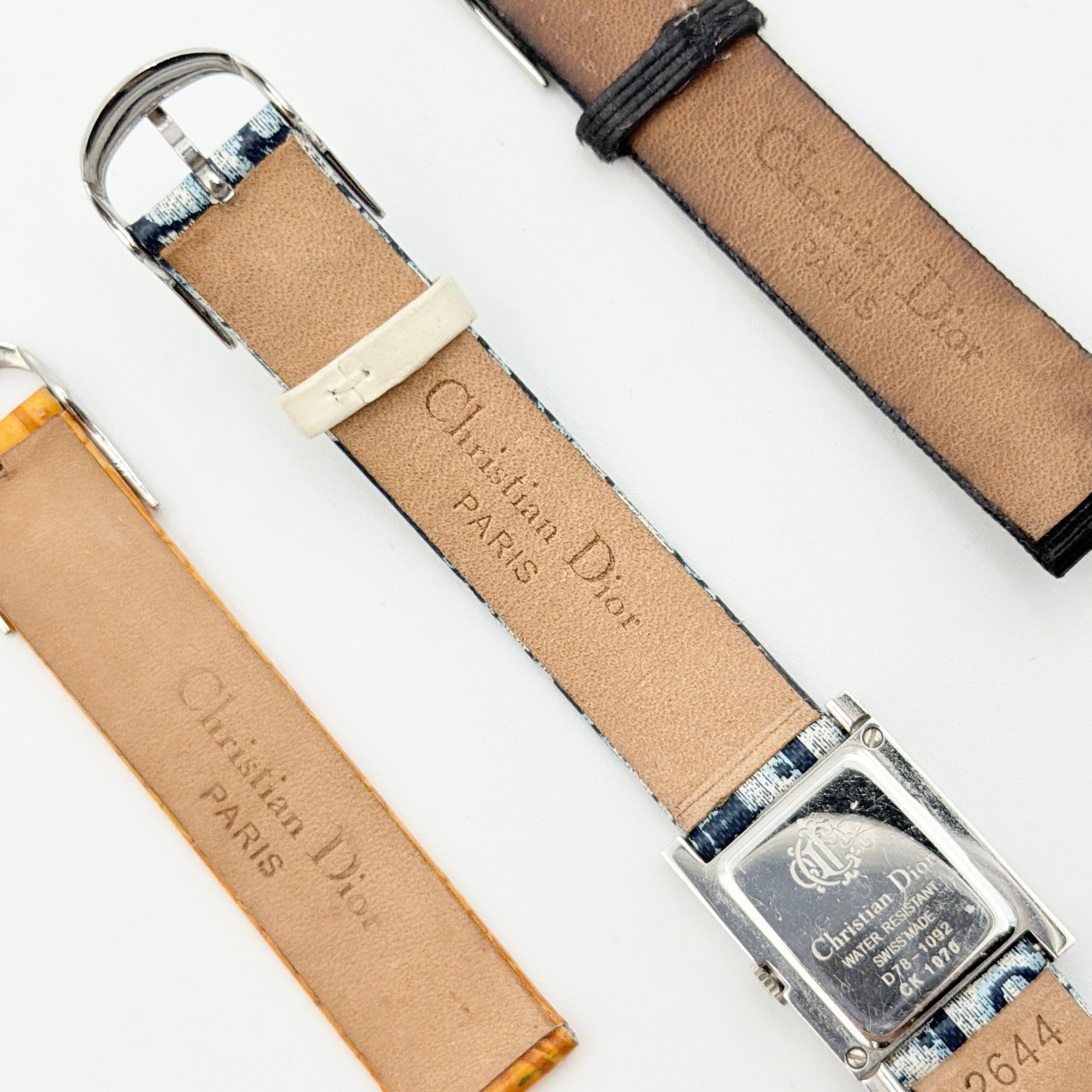 Dior Trotter Malice Watch with blue monogram strap and extra interchangeable yellow and black straps displayed.
