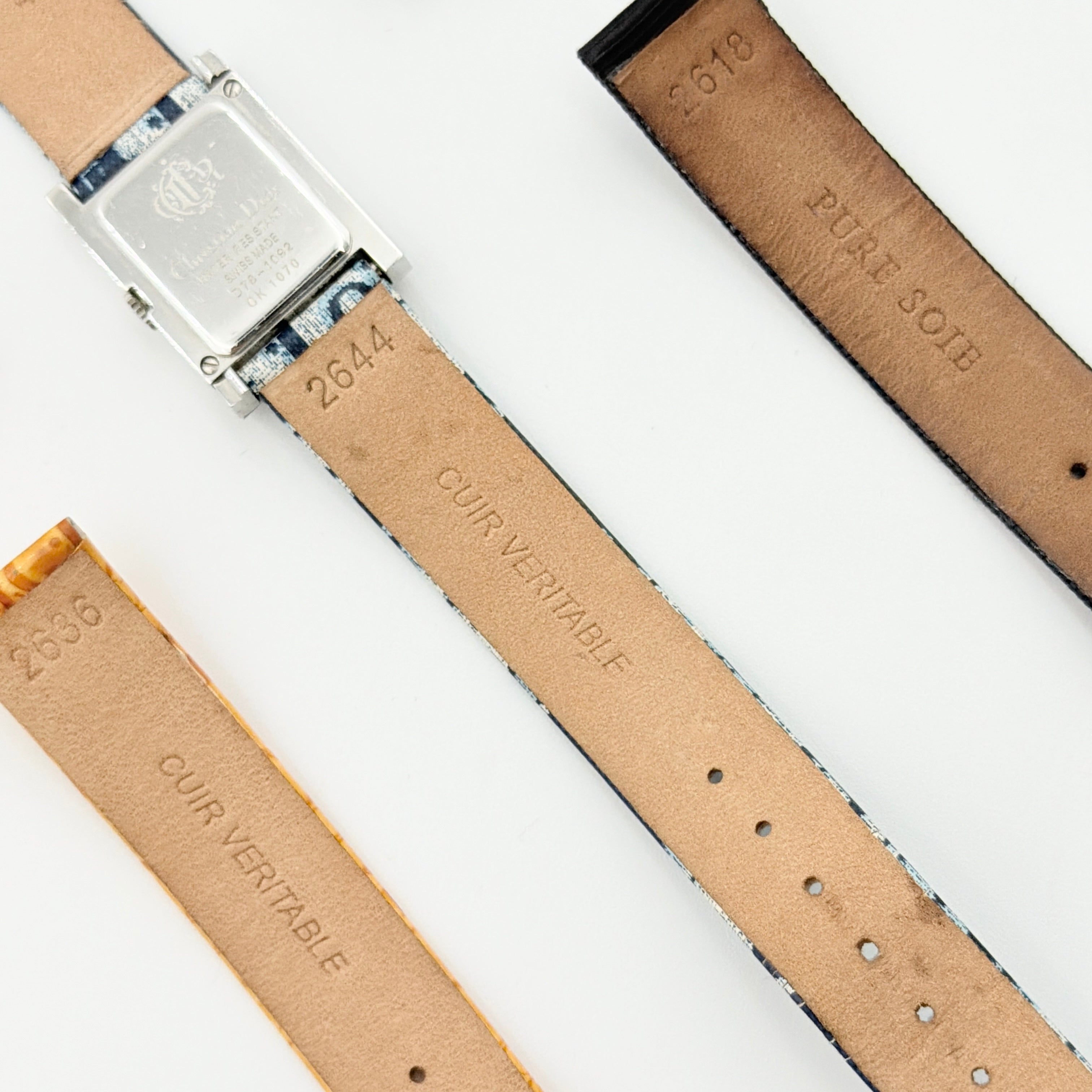 Dior Trotter Malice Watch with blue monogram strap and extra interchangeable yellow and black straps displayed.