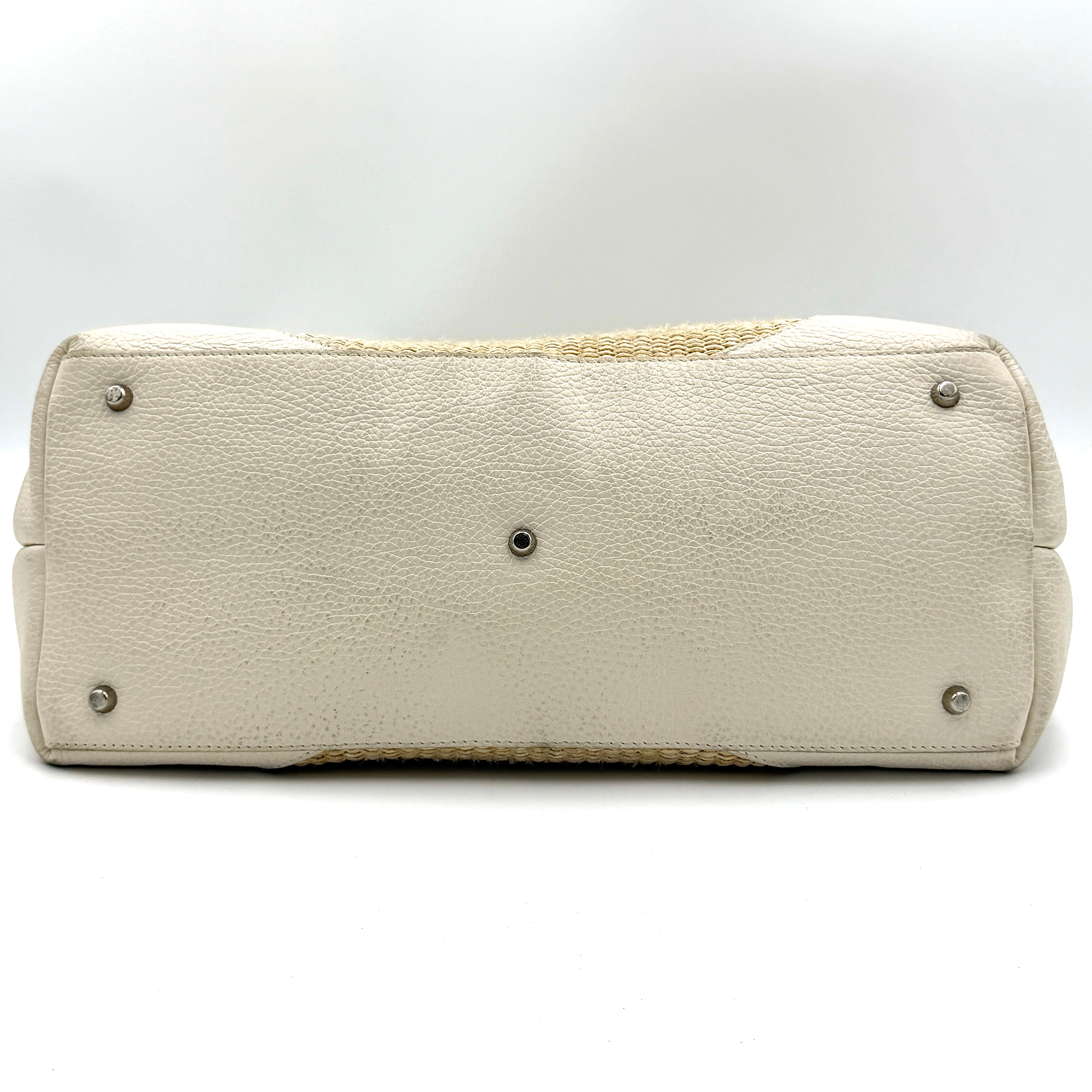 Furla beige woven straw tote bag with off-white leather handles and corners, featuring a silver oval logo plaque.