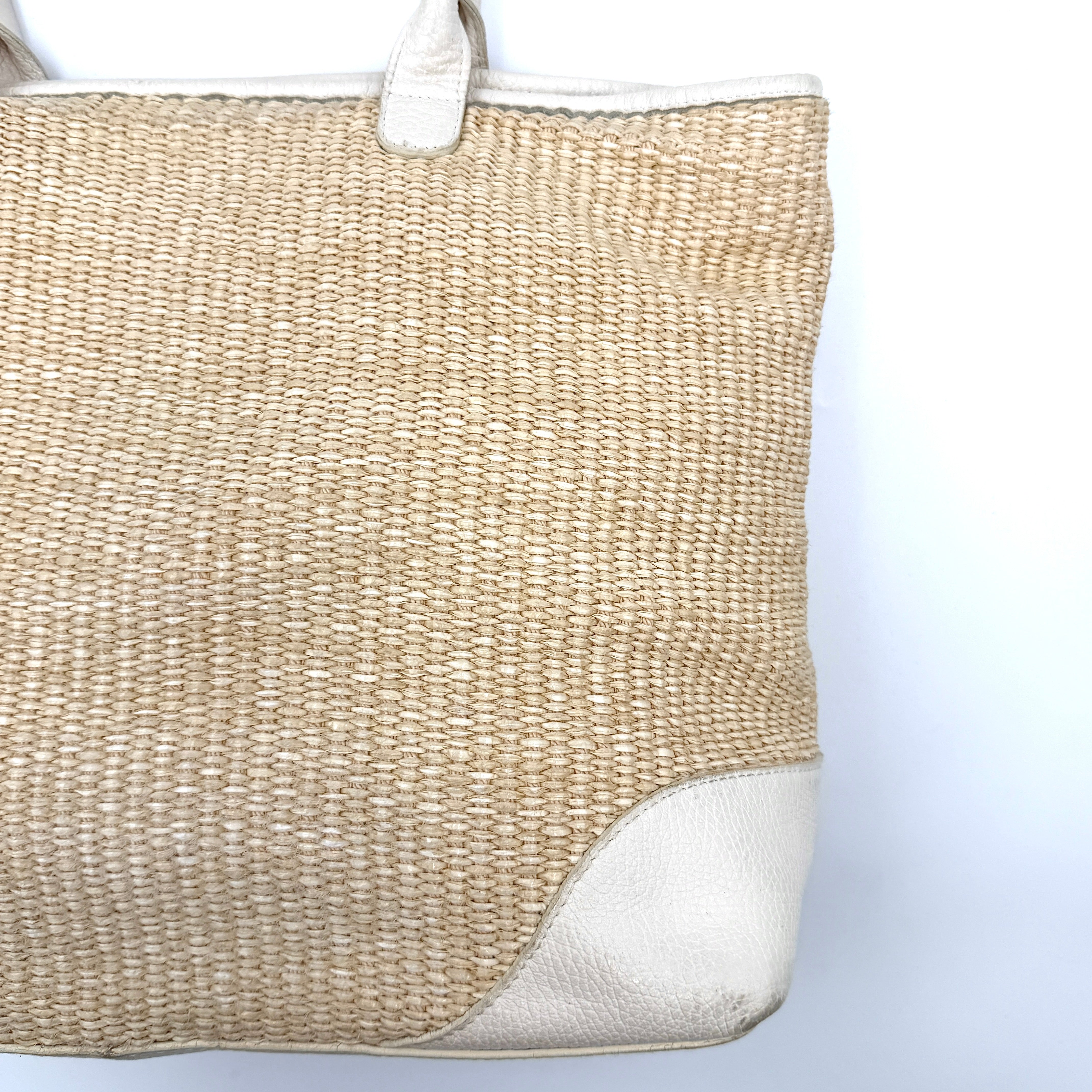 Furla beige woven straw tote bag with off-white leather handles and corners, featuring a silver oval logo plaque.