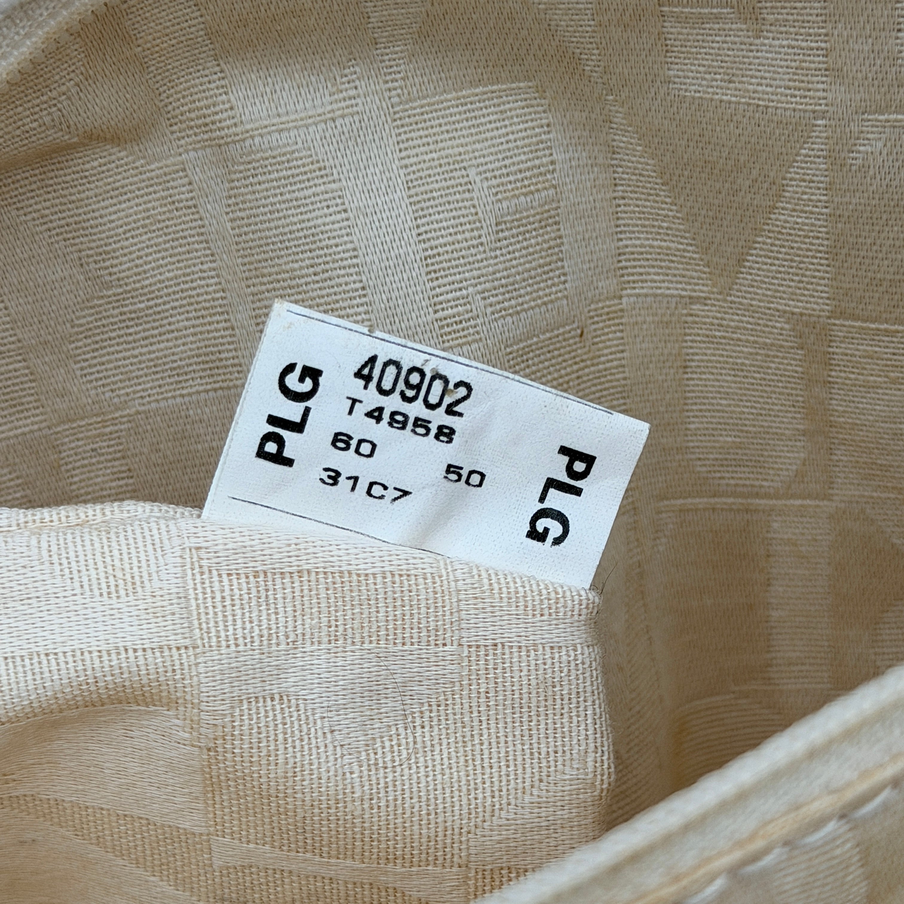 Furla beige woven straw tote bag with off-white leather handles and corners, featuring a silver oval logo plaque.
