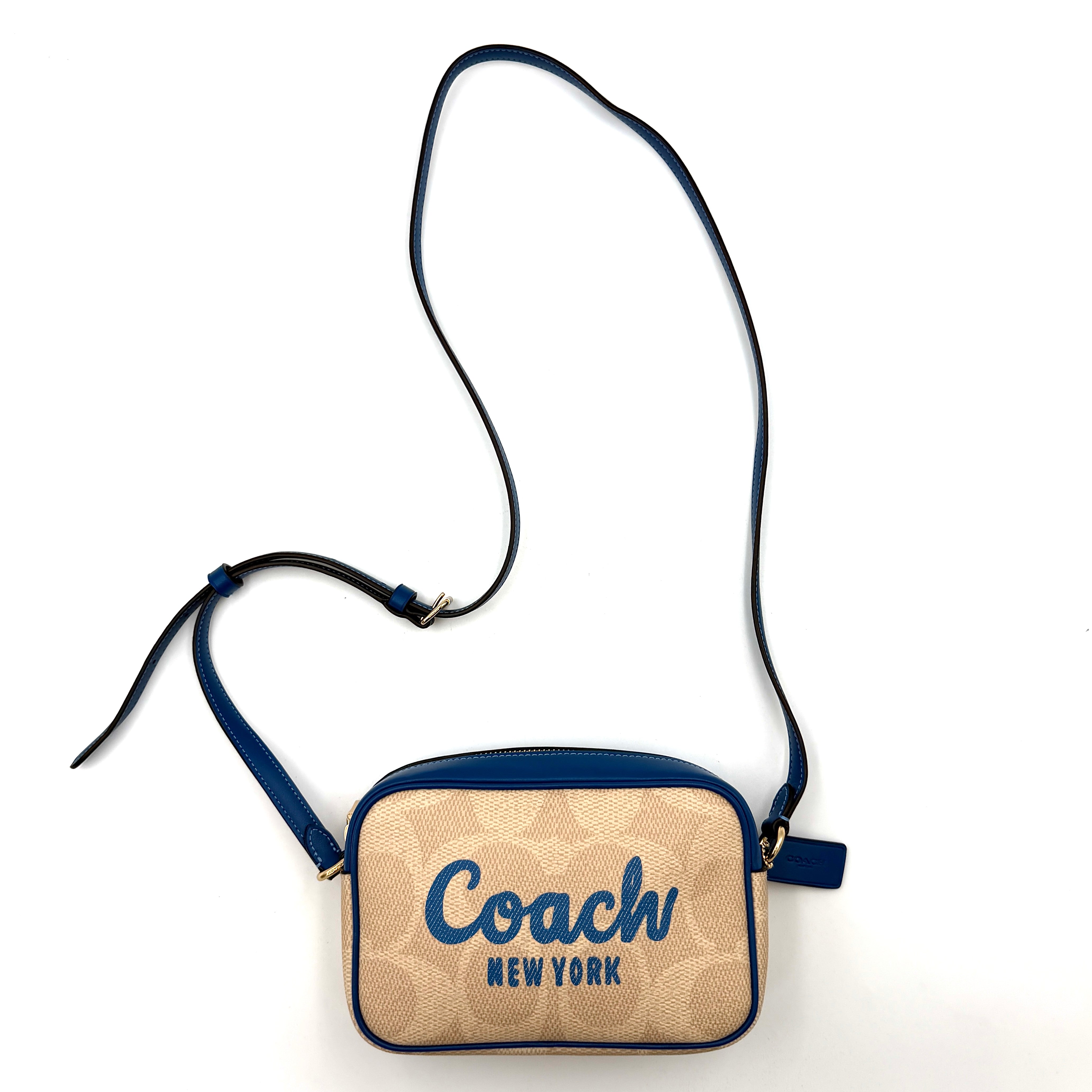 Coach Signature Jamie Camera Crossbody Bag in beige canvas with bold blue logo, cobalt trim, and adjustable blue leather strap.