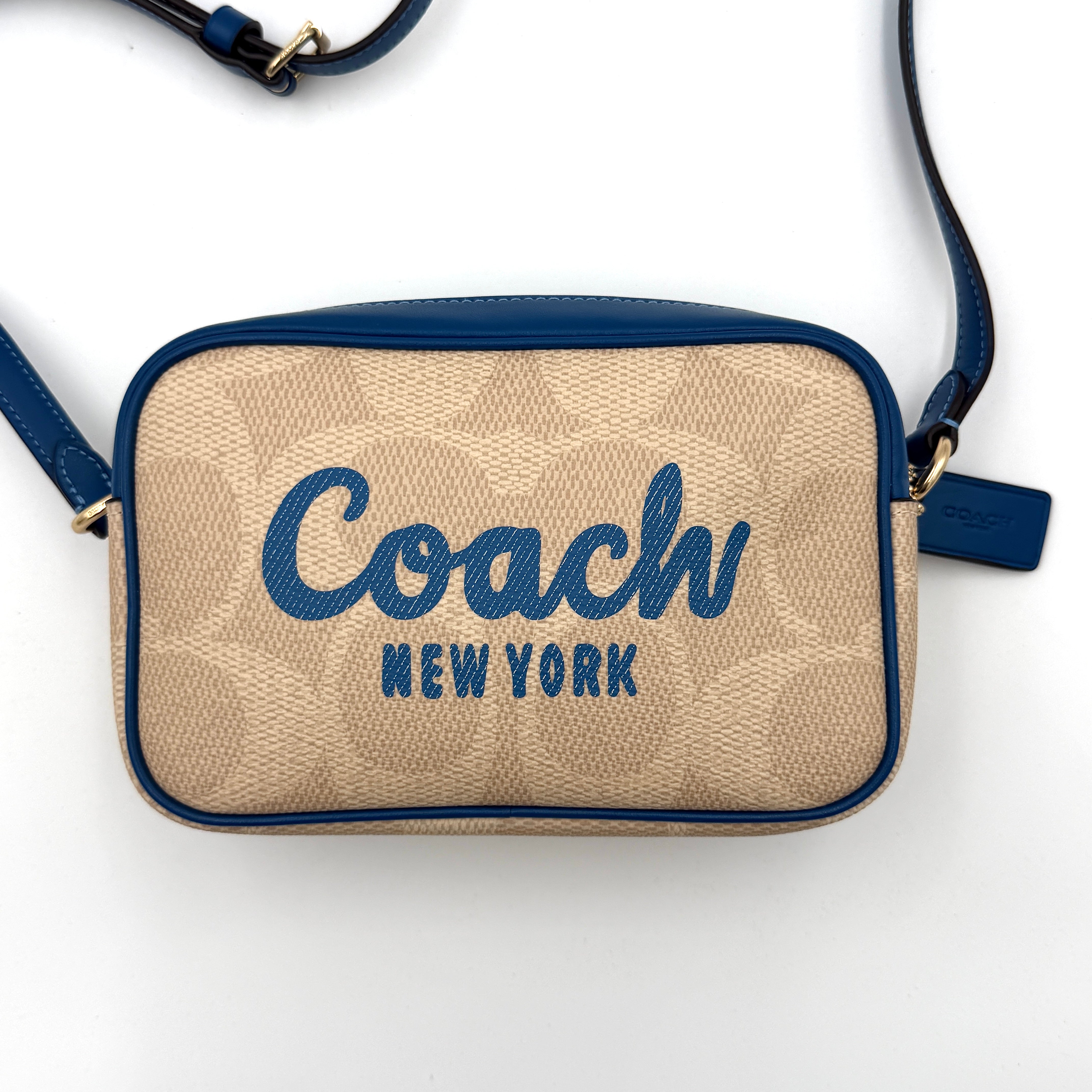 Coach Signature Jamie Camera Crossbody Bag in beige canvas with bold blue logo, cobalt trim, and adjustable blue leather strap.