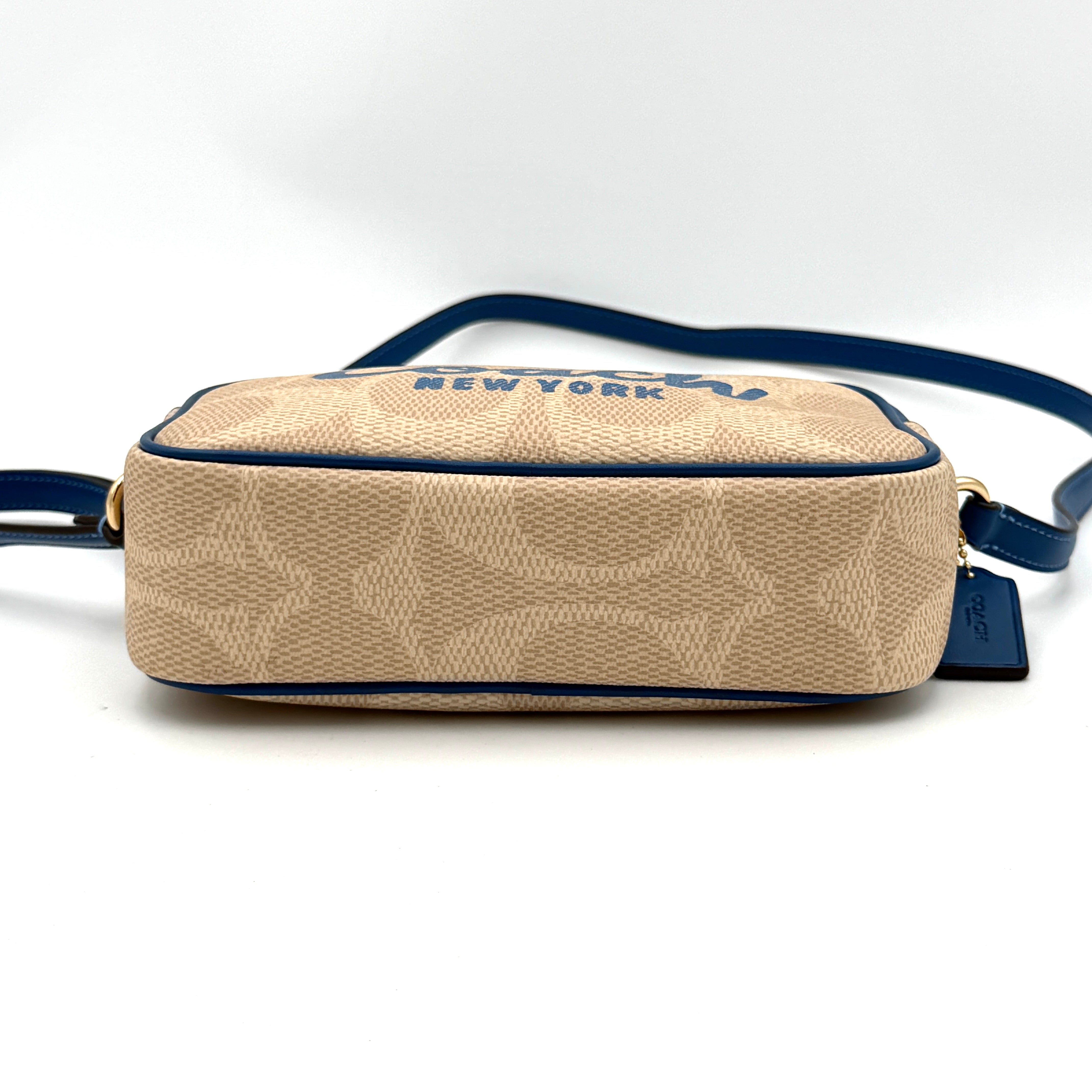 Coach Signature Jamie Camera Crossbody Bag in beige canvas with bold blue logo, cobalt trim, and adjustable blue leather strap.