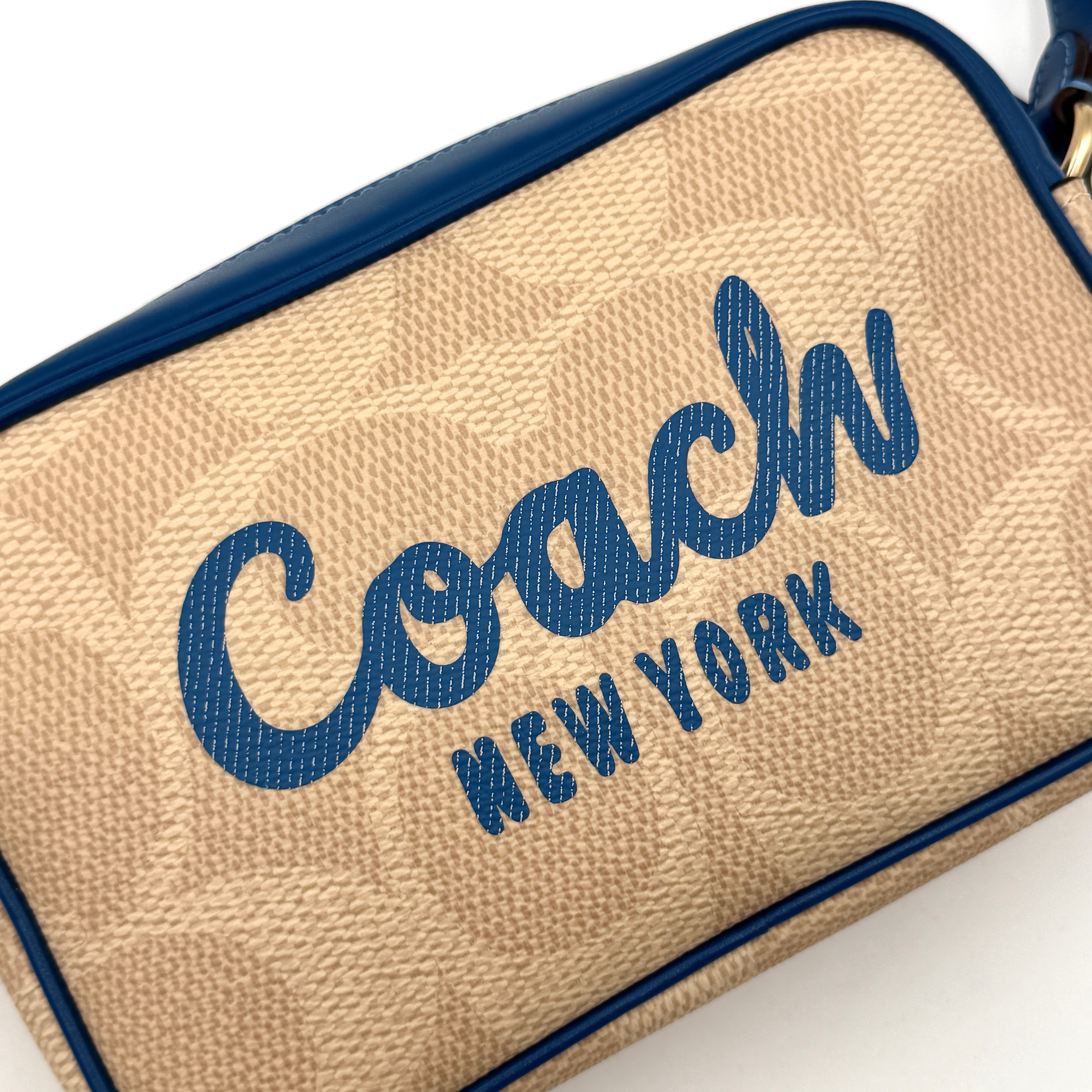 Coach Signature Jamie Camera Crossbody Bag in beige canvas with bold blue logo, cobalt trim, and adjustable blue leather strap.