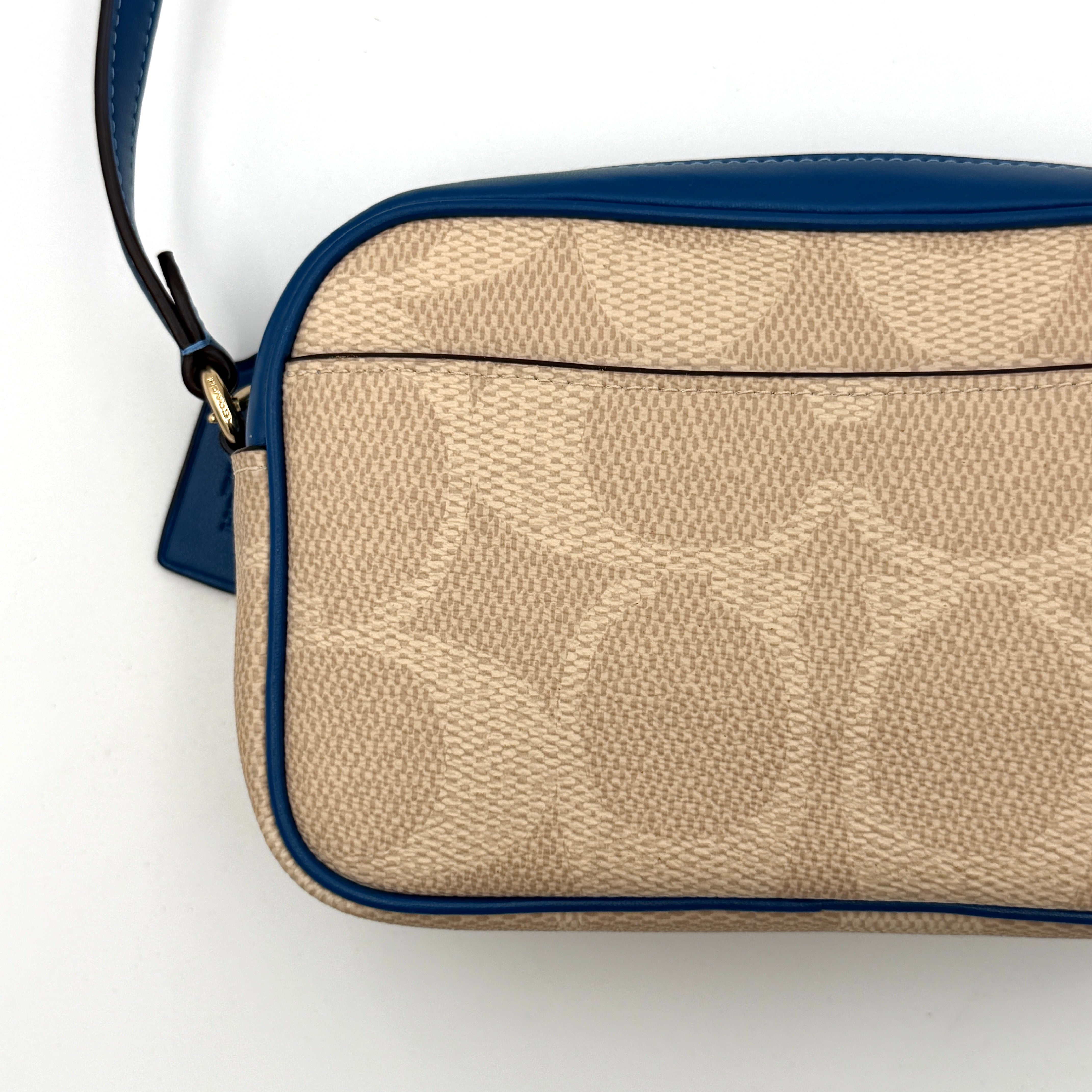 Coach Signature Jamie Camera Crossbody Bag in beige canvas with bold blue logo, cobalt trim, and adjustable blue leather strap.