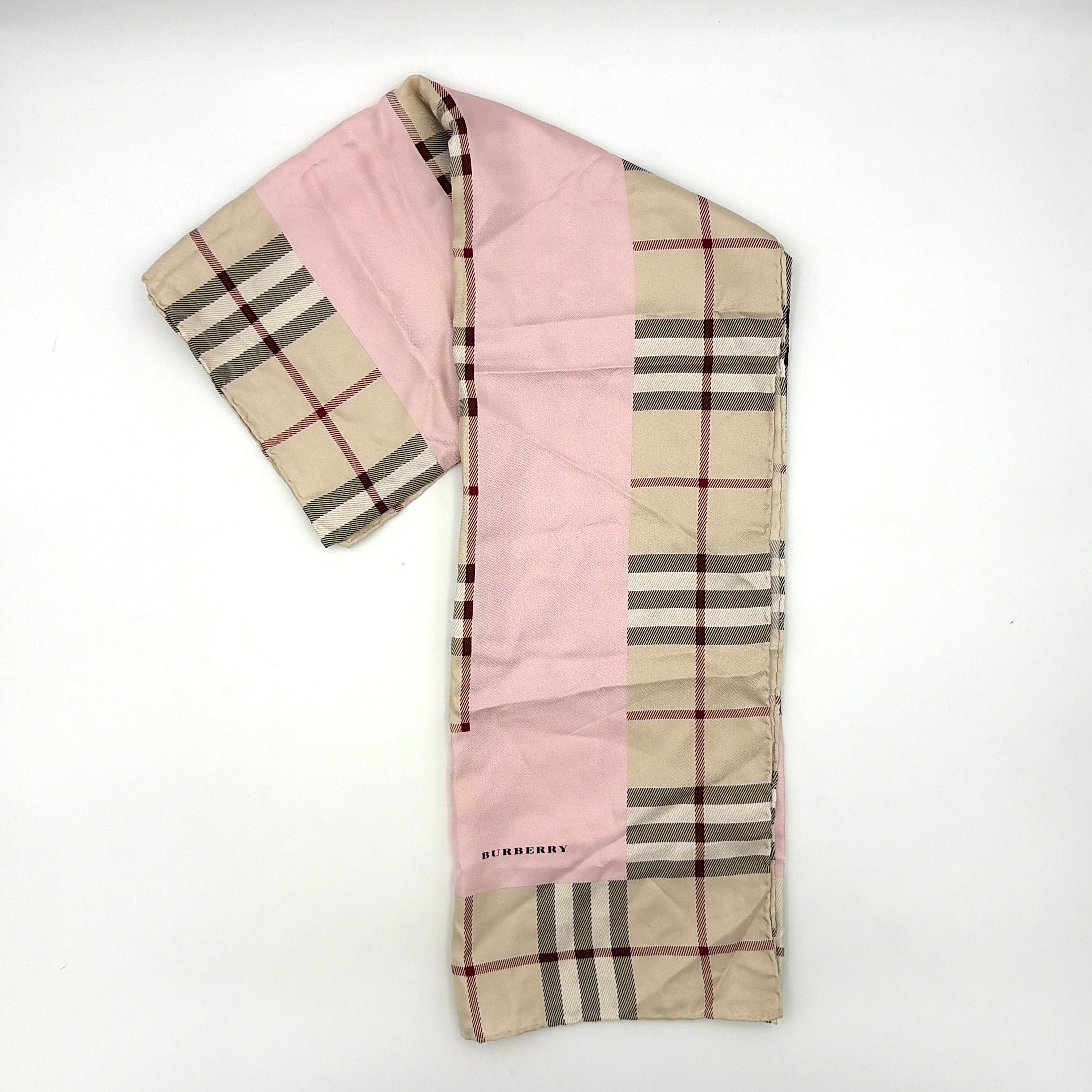 Burberry silk scarf in pale pink and beige, showcasing the iconic Nova Check pattern with burgundy highlights and a subtle brand signature.