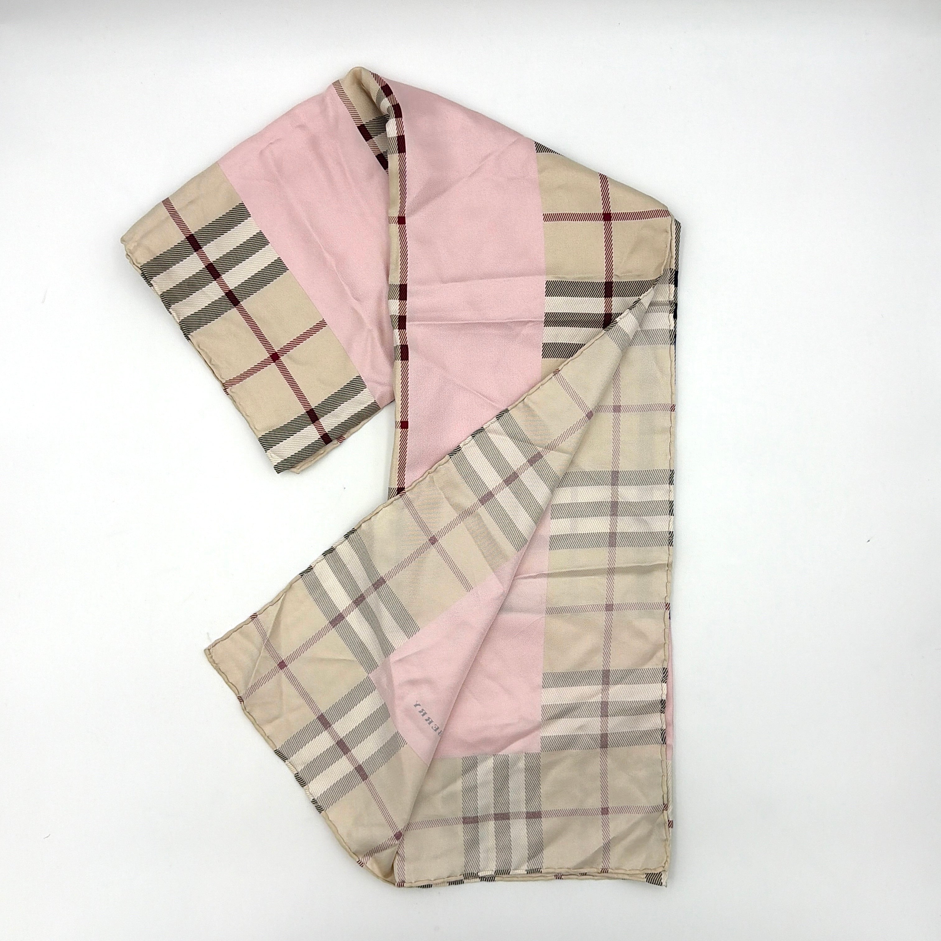 Burberry silk scarf in pale pink and beige, showcasing the iconic Nova Check pattern with burgundy highlights and a subtle brand signature.