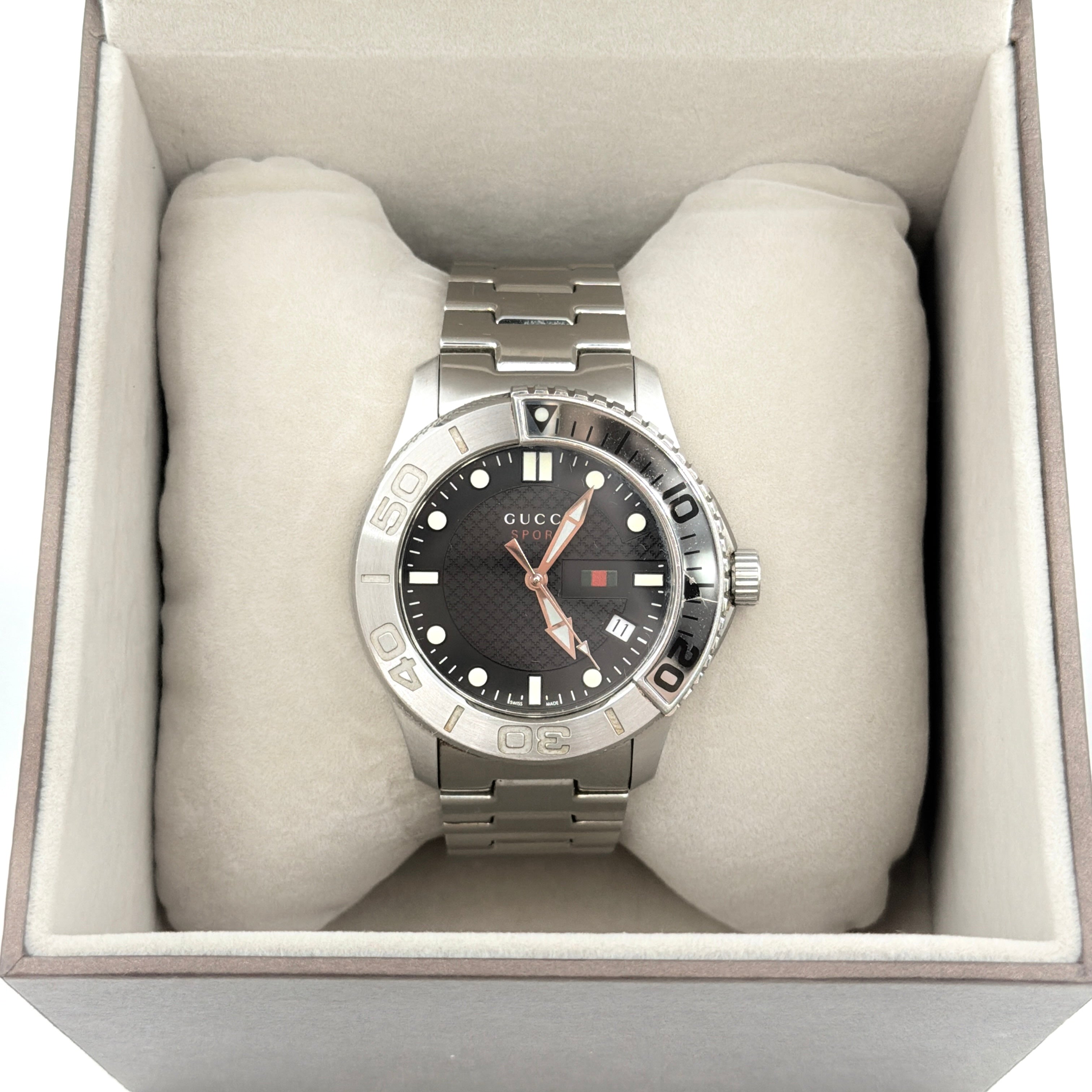 Gucci G-Timeless Sport Watch in silver with black dial, presented in its original box with booklet and extra links.