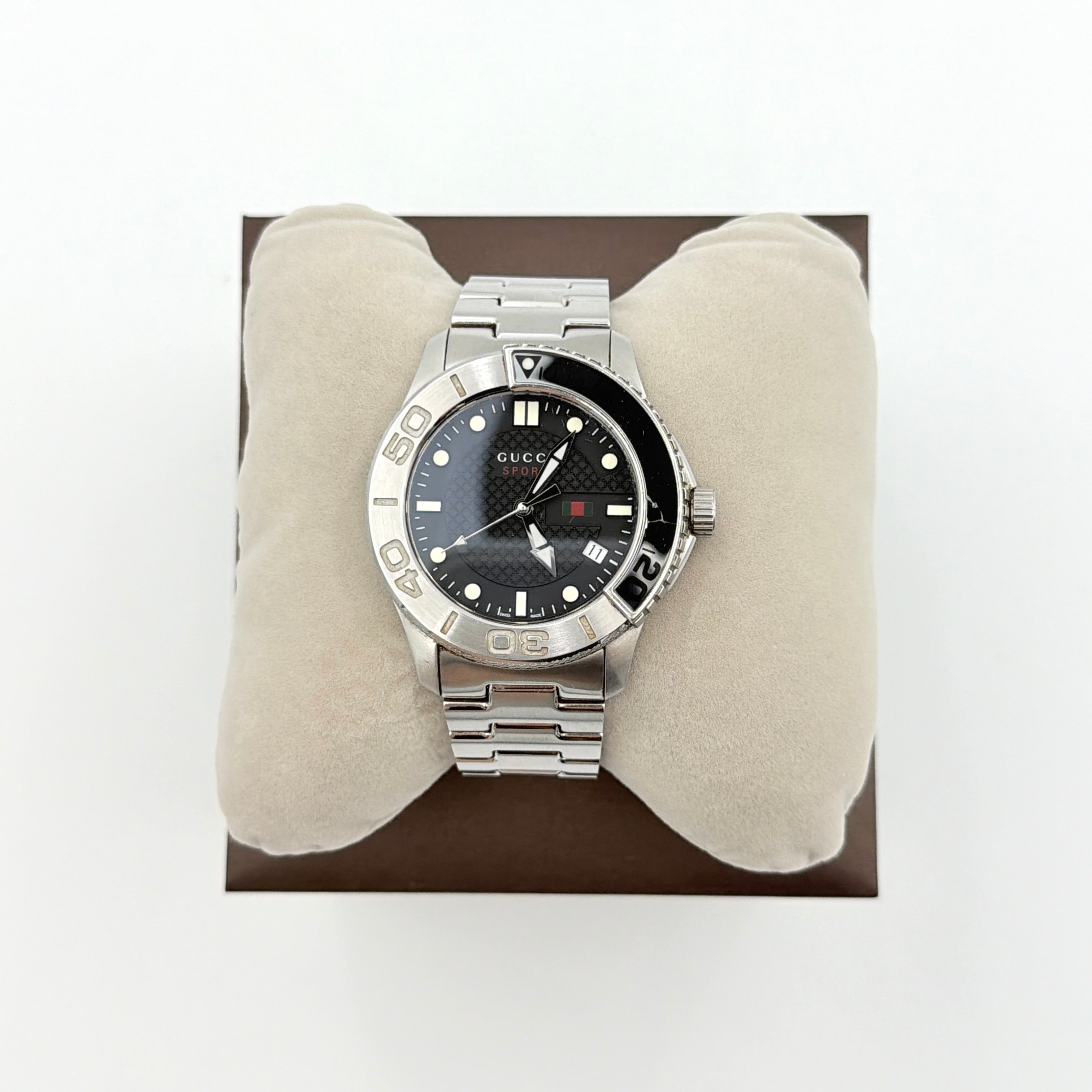 Gucci G-Timeless Sport Watch in silver with black dial, presented in its original box with booklet and extra links.