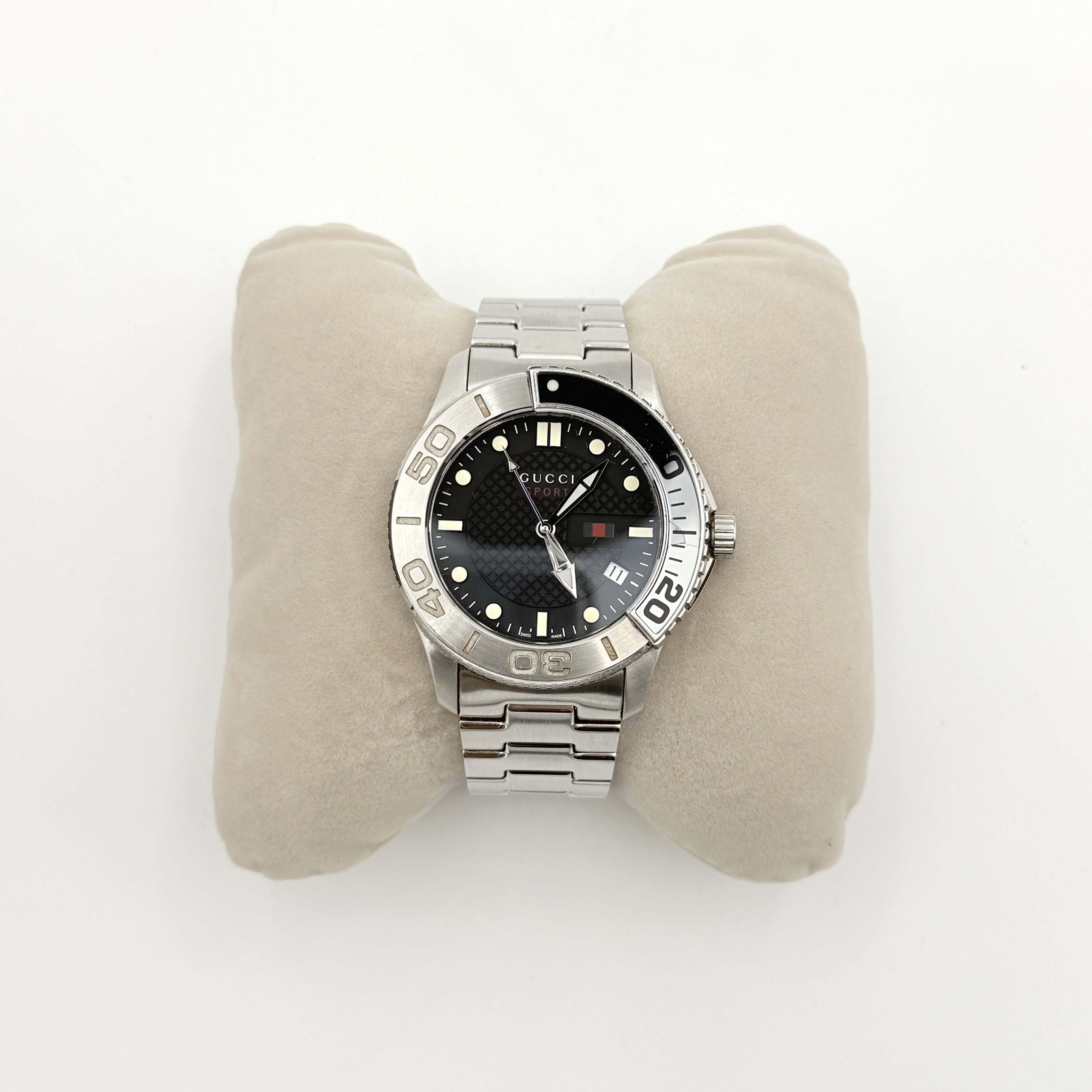 Gucci G-Timeless Sport Watch in silver with black dial, presented in its original box with booklet and extra links.