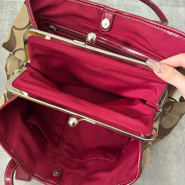 Coach Framed Kiss Lock Carryall Satchel in tan and red stripe with signature monogram canvas, silver-tone hardware, and spacious red fabric-lined interior.