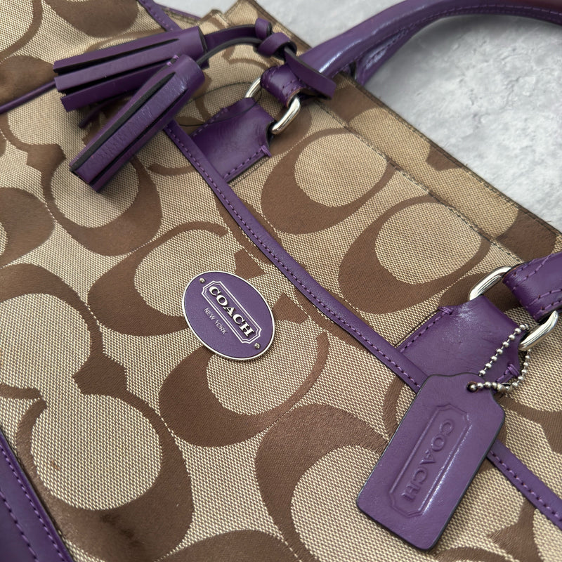 Coach Signature Legacy Candace Carry-All handbag in beige coated canvas with monogram print, purple leather trim, silver-tone hardware, and tassel details.