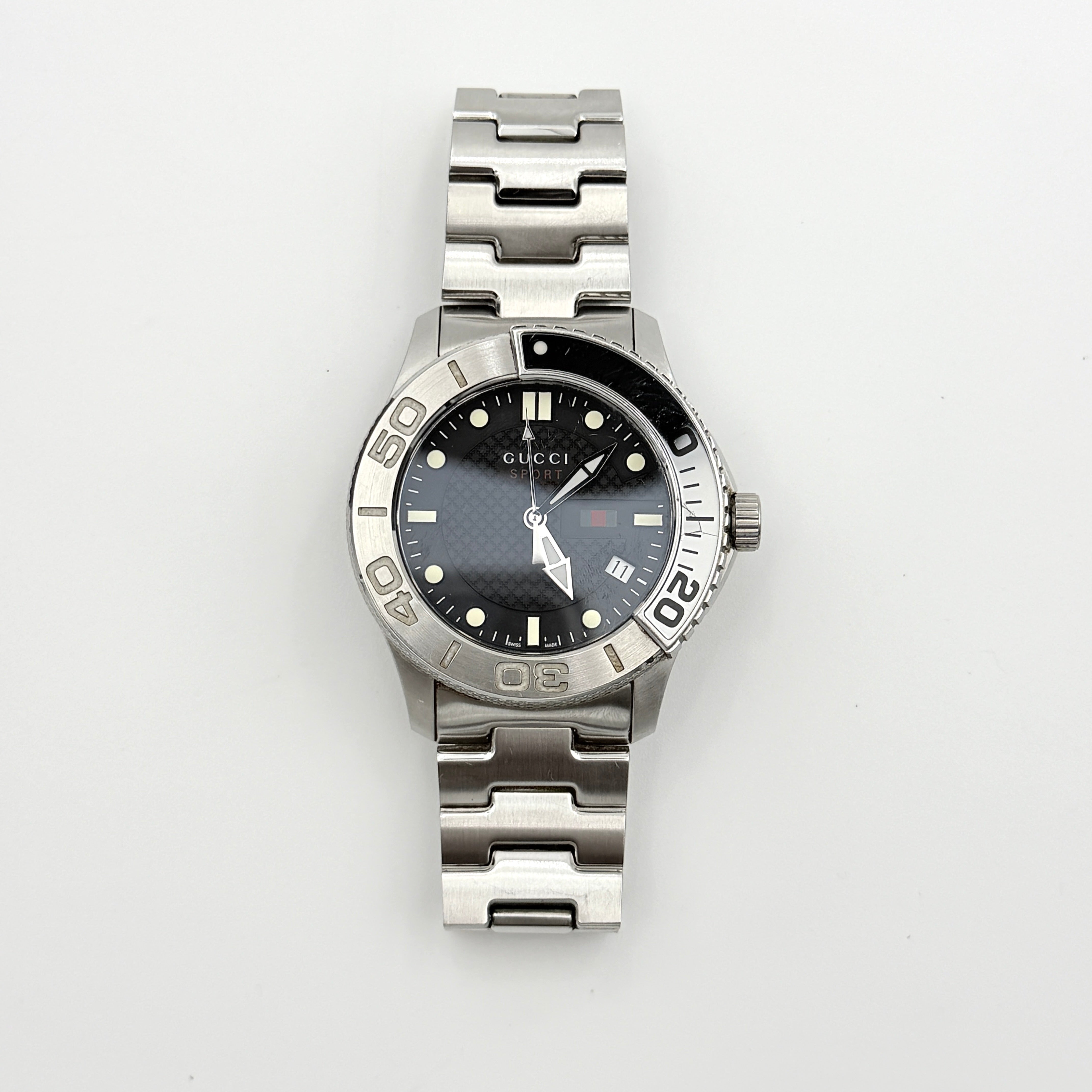 Gucci G-Timeless Sport Watch in silver with black dial, presented in its original box with booklet and extra links.