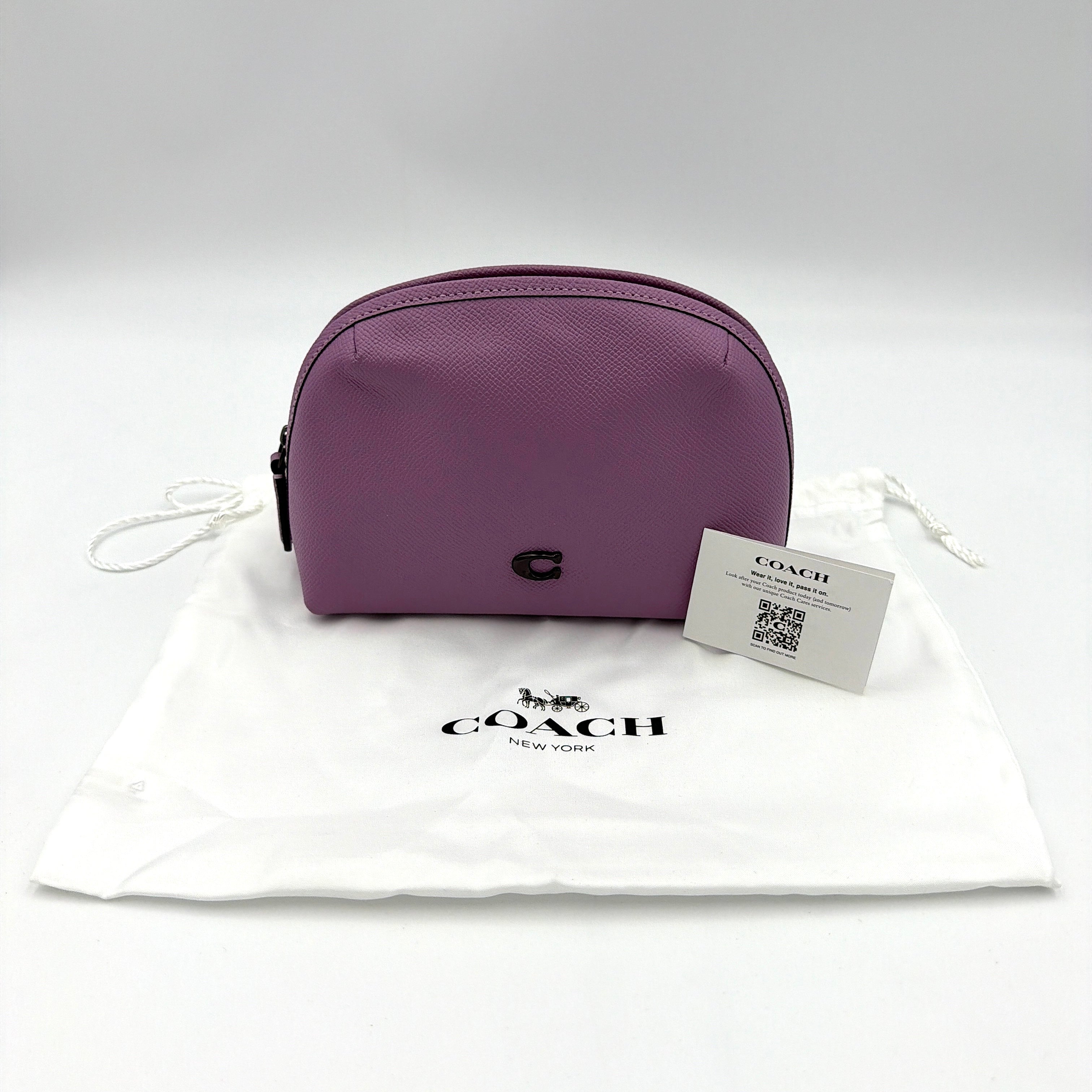 Coach Julienne Cosmetic Case 17 in purple grained leather with black hardware, photographed on a plain background.