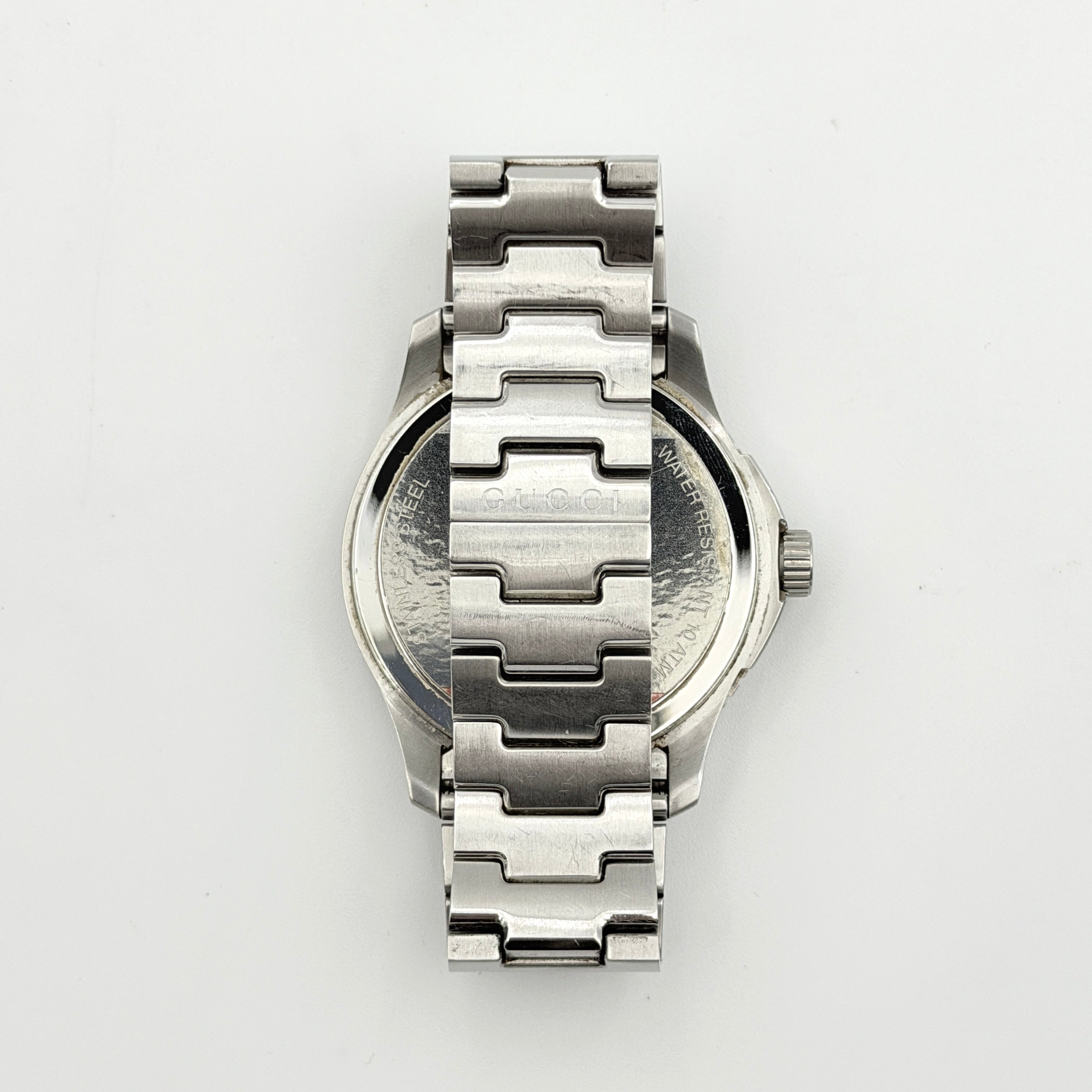 Gucci G-Timeless Sport Watch in silver with black dial, presented in its original box with booklet and extra links.