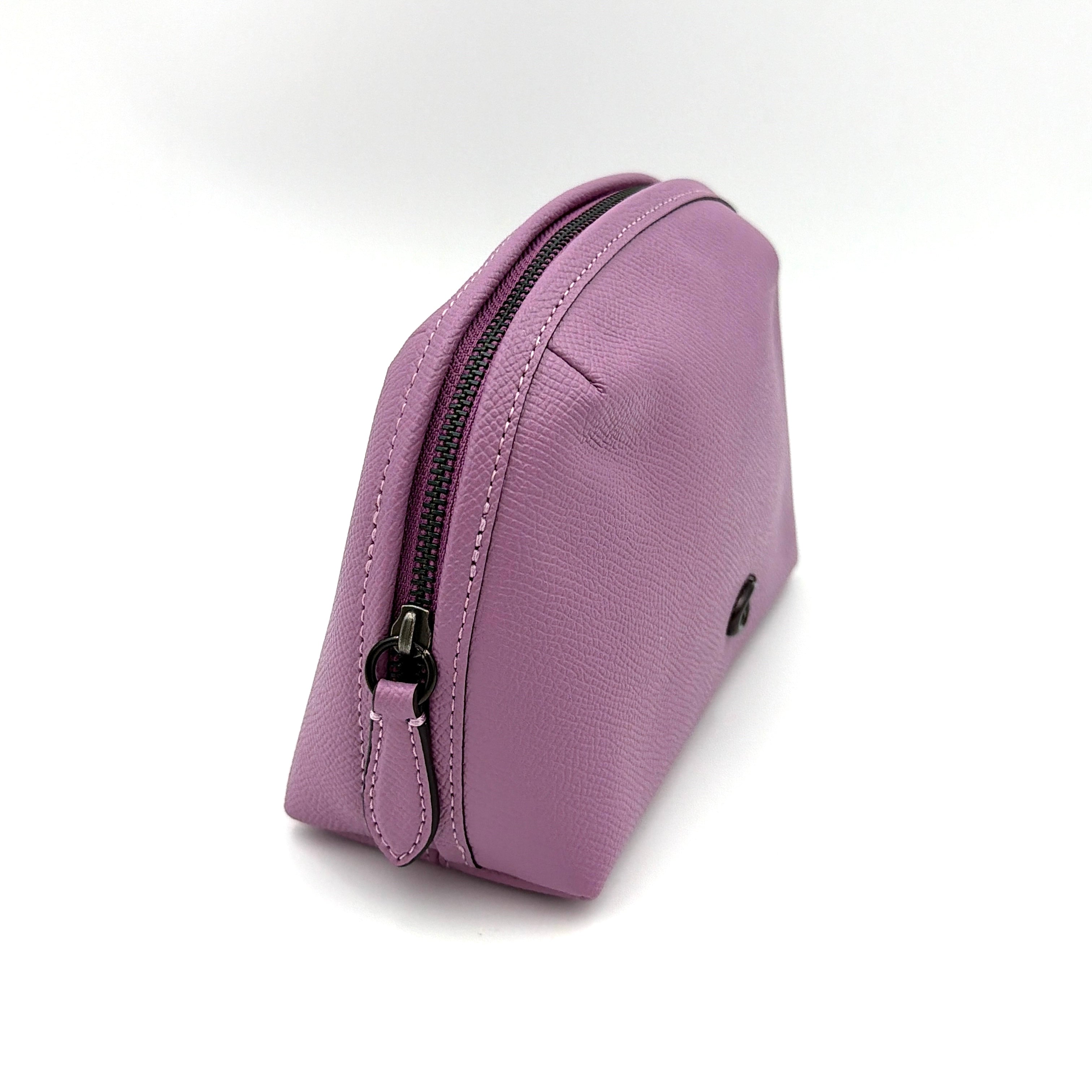 Coach Julienne Cosmetic Case 17 in purple grained leather with black hardware, photographed on a plain background.