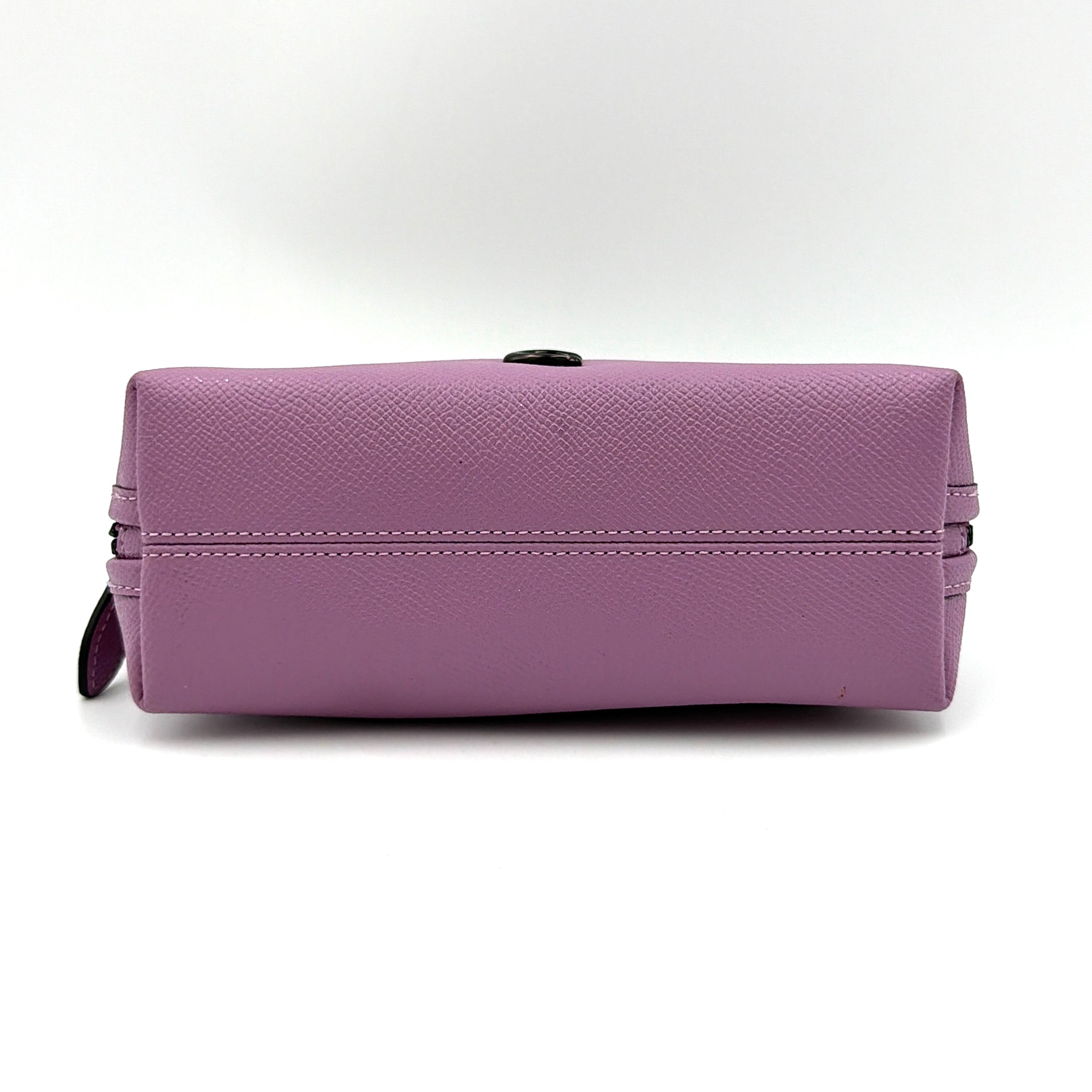 Coach Julienne Cosmetic Case 17 in purple grained leather with black hardware, photographed on a plain background.