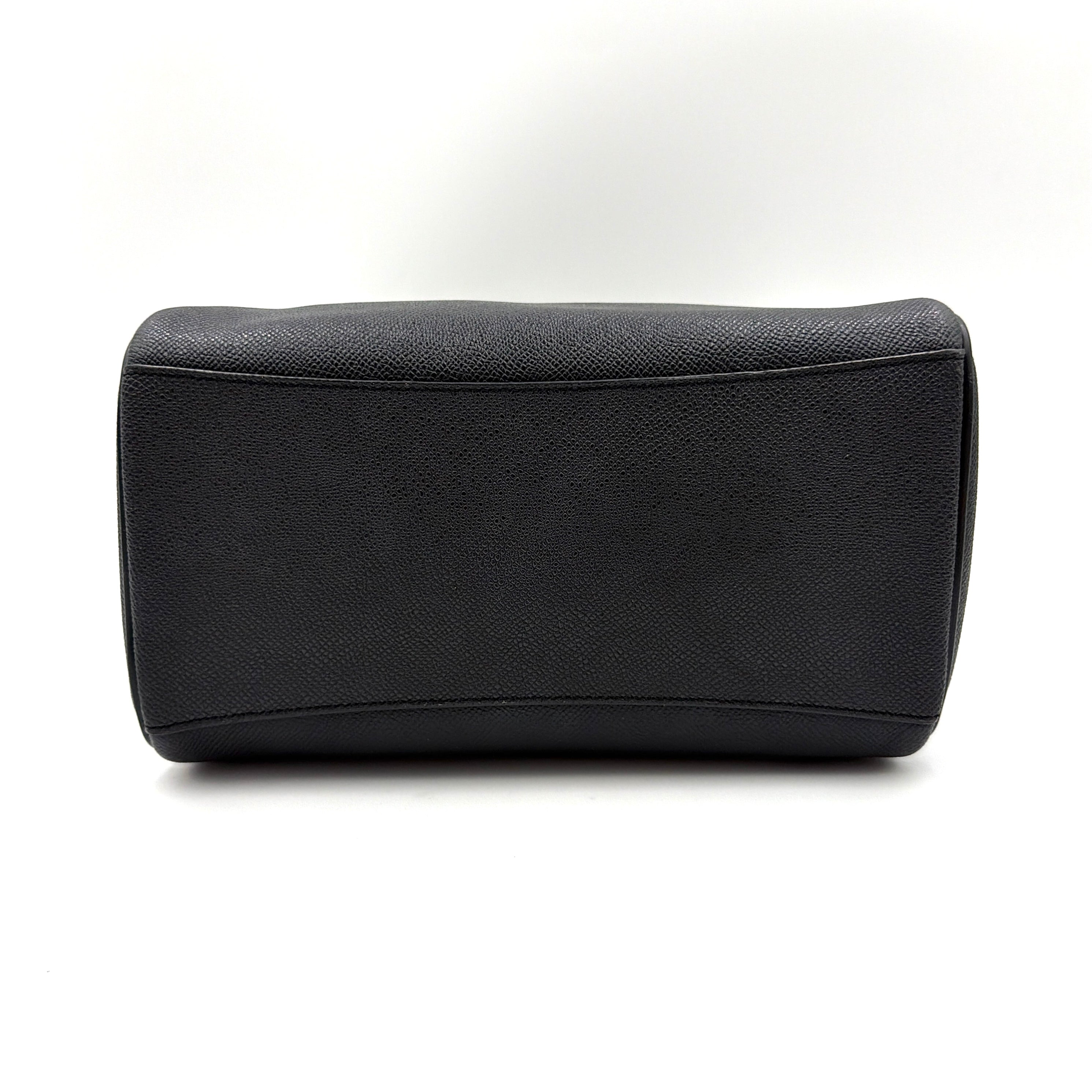 Coach Mini Bennett Boston Bag in black pebbled leather with gold hardware and detachable strap, styled against a clean backdrop.