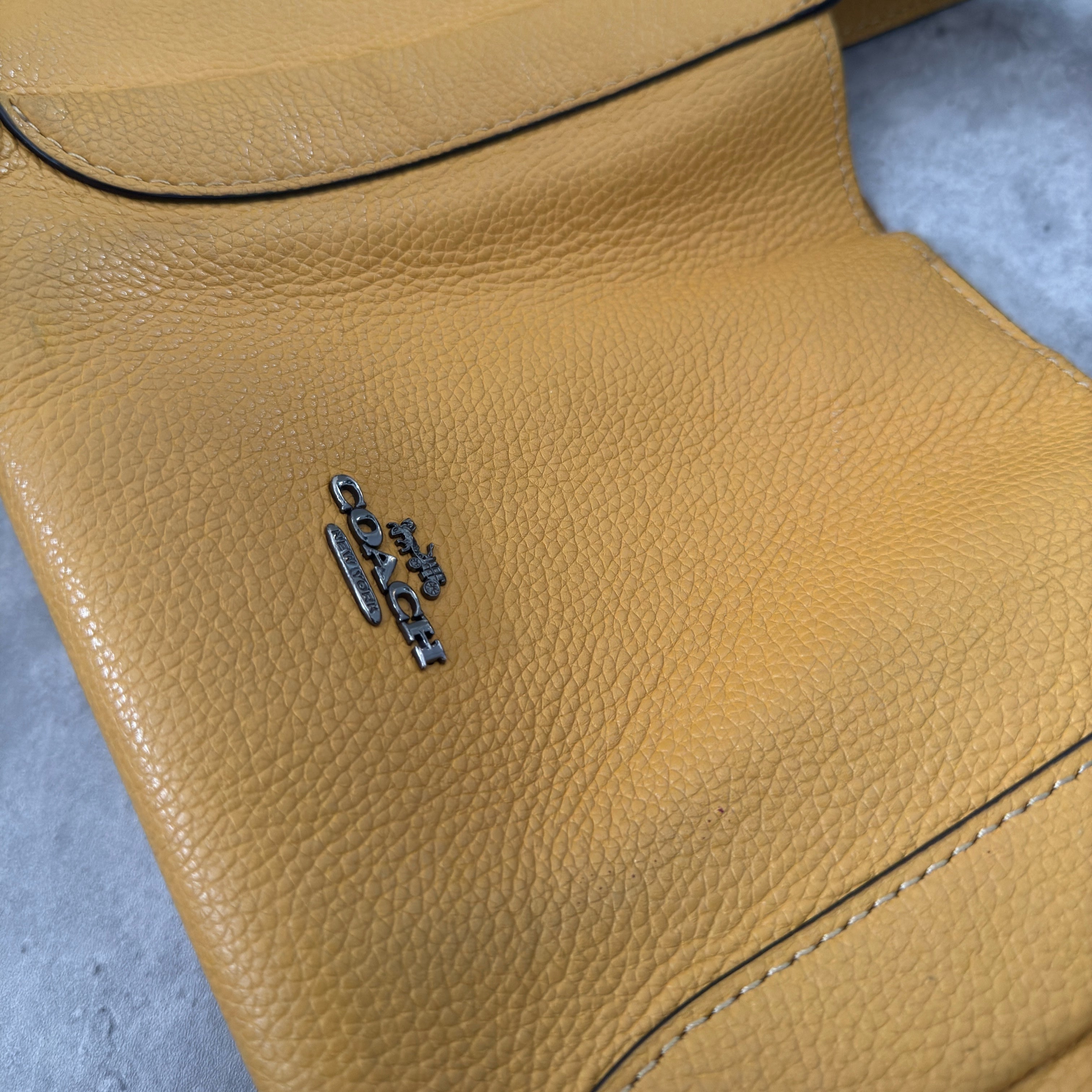 Coach Mini Yellow Leather Bag with pebbled leather texture, dual top handles, and a spacious open interior.