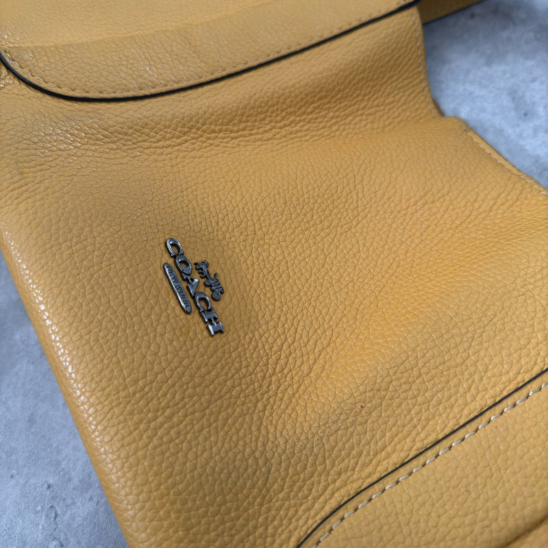 Coach Mini Yellow Leather Bag with pebbled leather texture, dual top handles, and a spacious open interior.